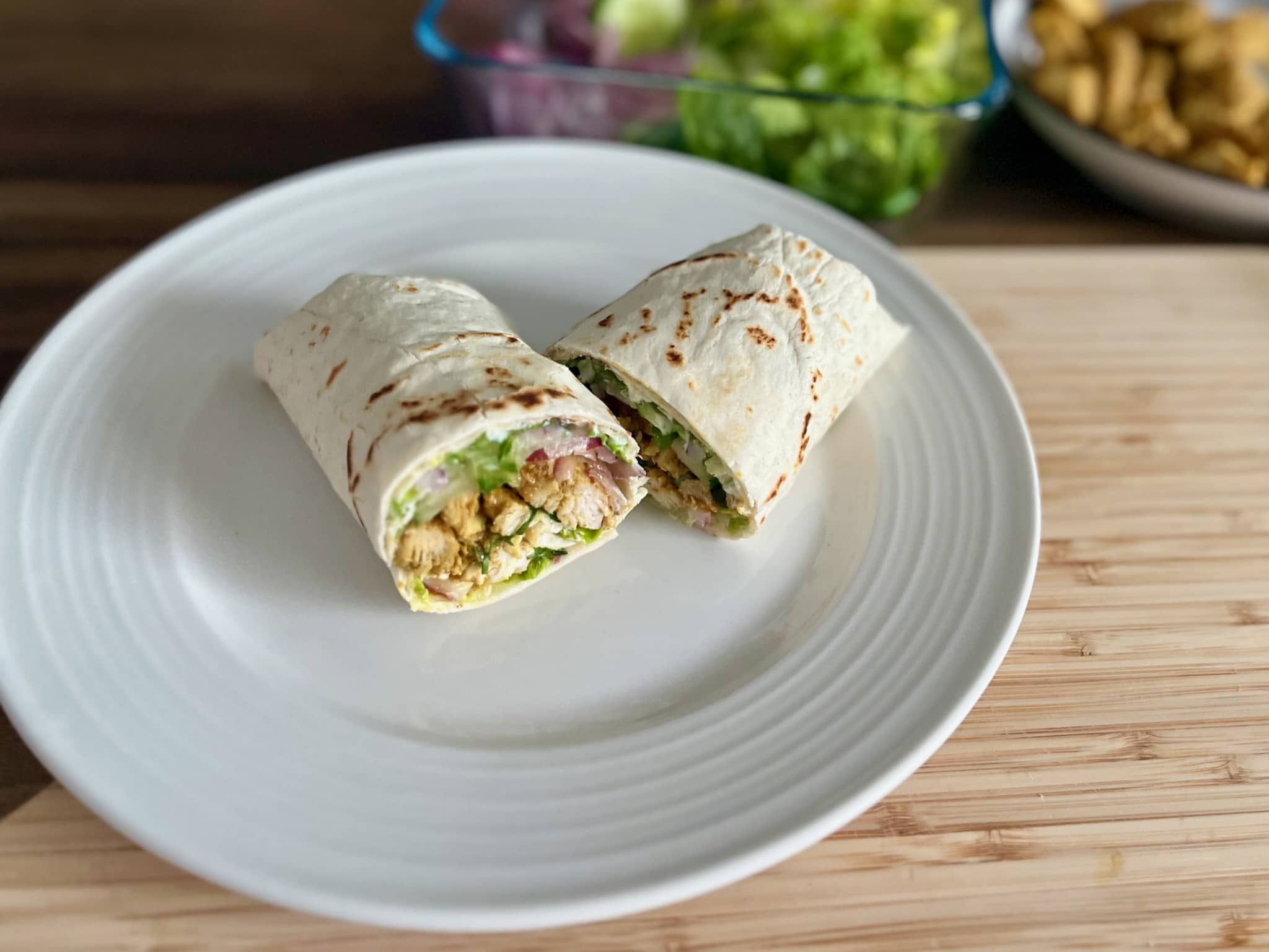 Fit Chicken Kebab Wrap cud in two placed on a plate