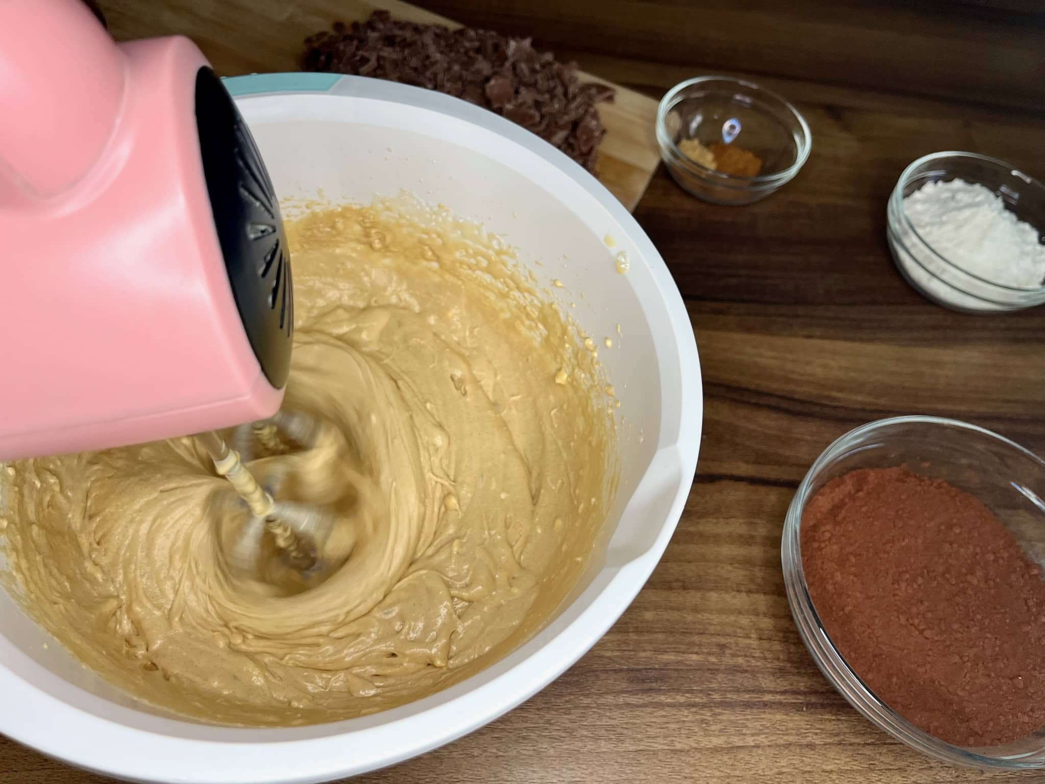 Incorporating softened butter into the creamed egg mixture in a mixing bowl