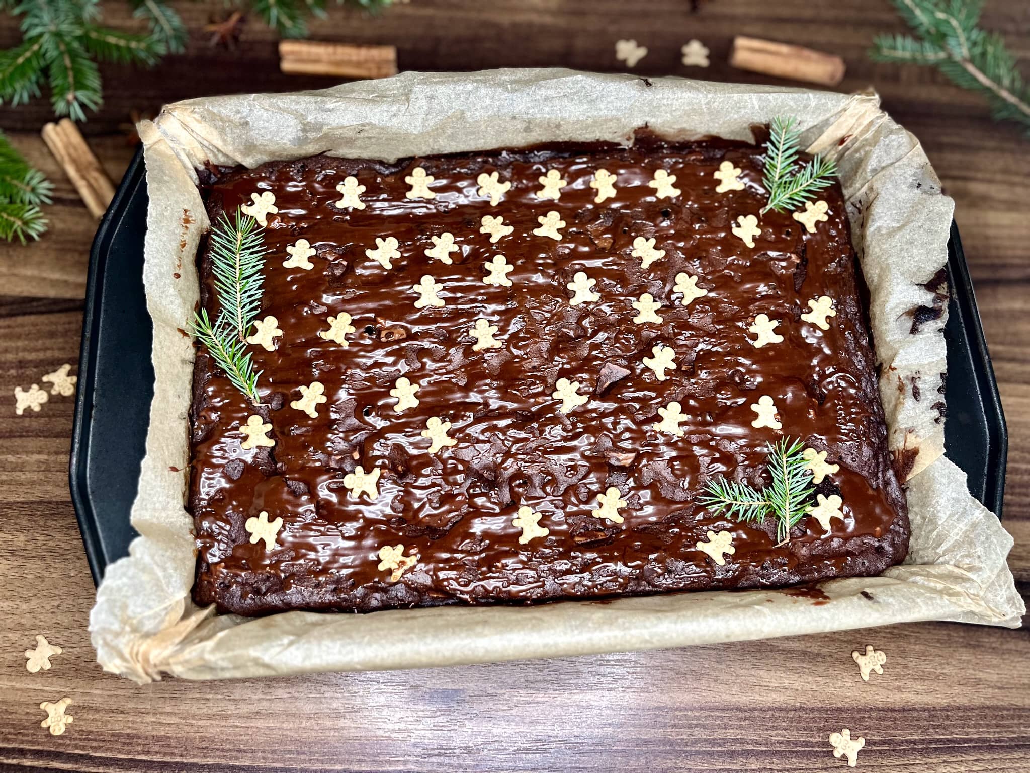 A beautifully decorated Gingerbread Brownie, still warm and gooey, basking in its baking tray