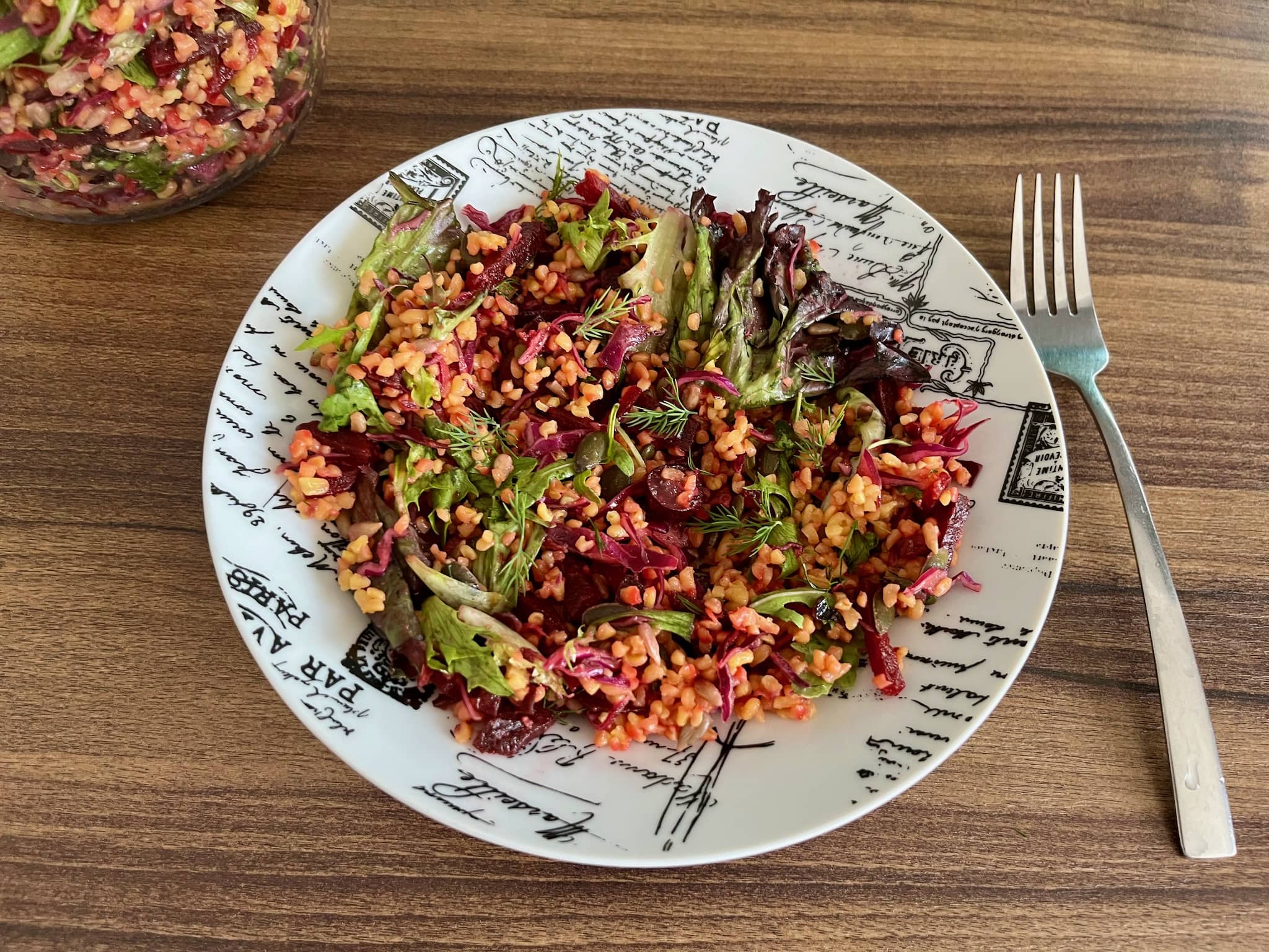 A portion of grainy beetroot and bulgur salad on a plate