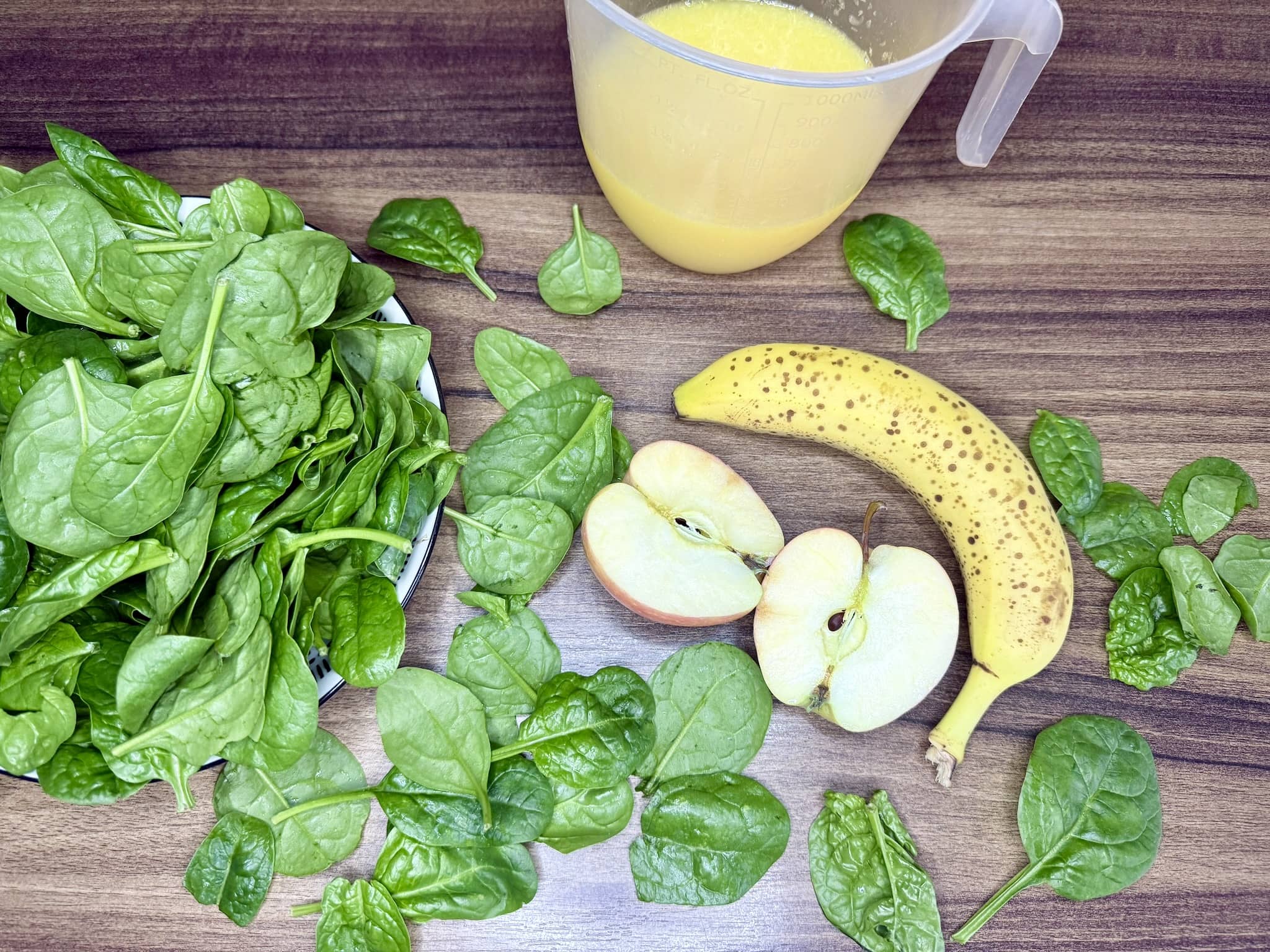 Ingredients spread out on a tabletop, ready to make Green Smoothie with Spinach