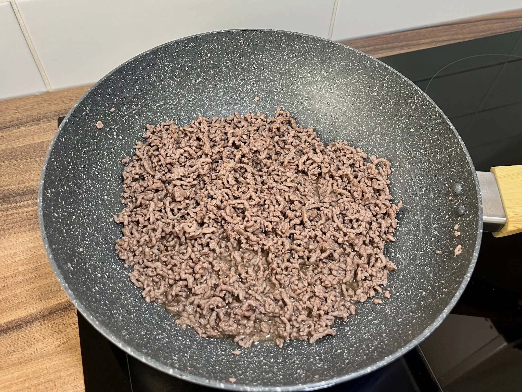 Browned ground beef in a frying pan