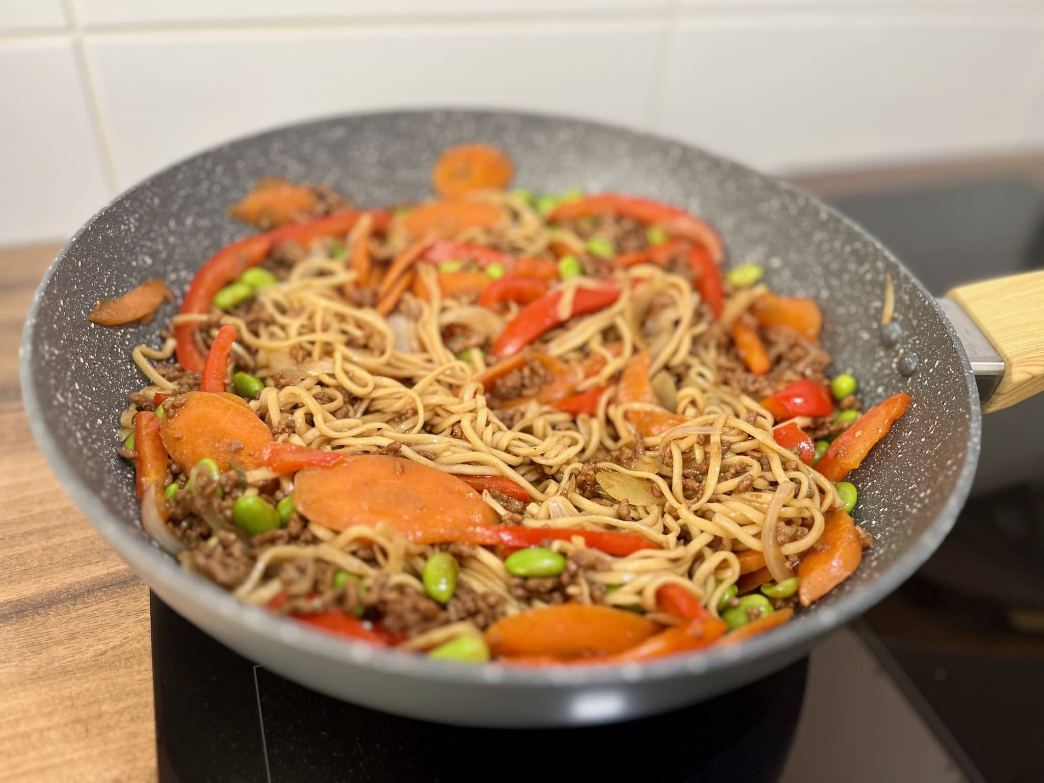 Ground beef stir-fry is almost ready in the pan