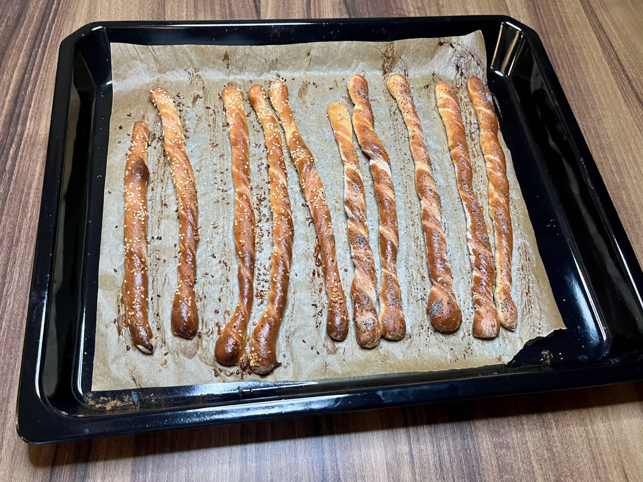 Nicely baked breadsticks still on a baking tray