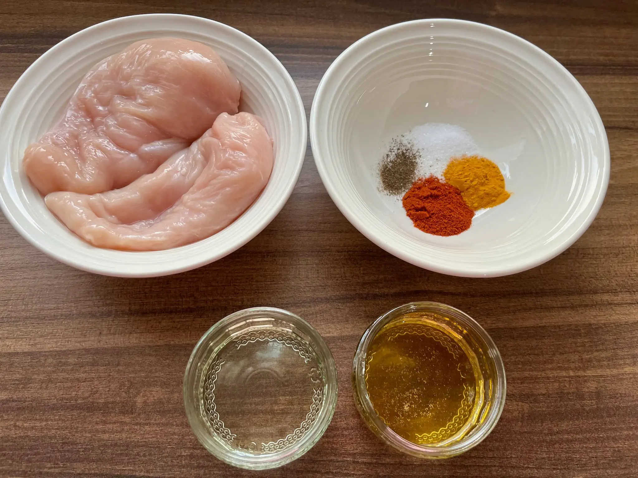 All of the ingredients for honey chicken rice bowl are laid out on a table, ready to be cooked