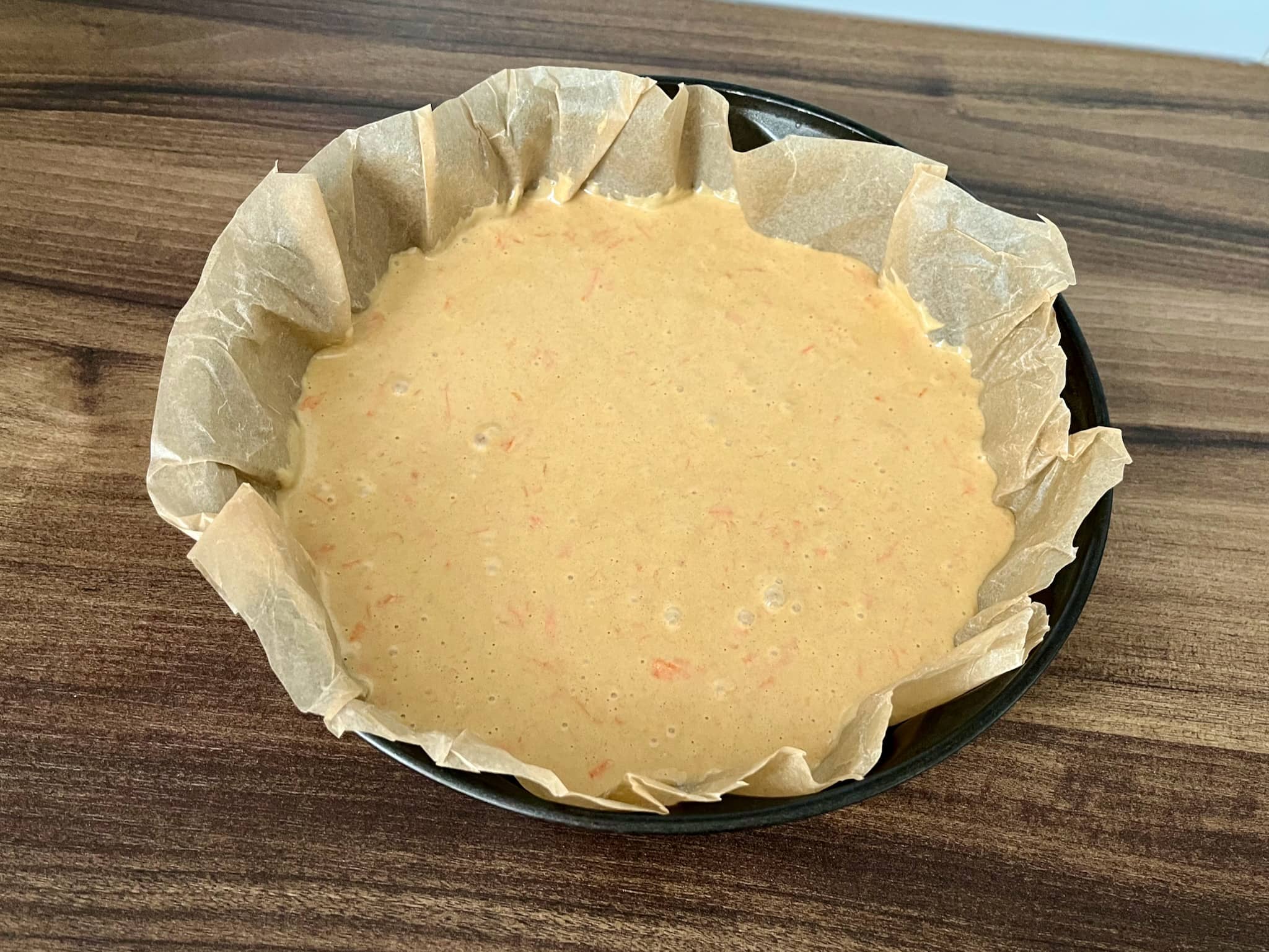 The cake mixture is in a baking pan, just before baking