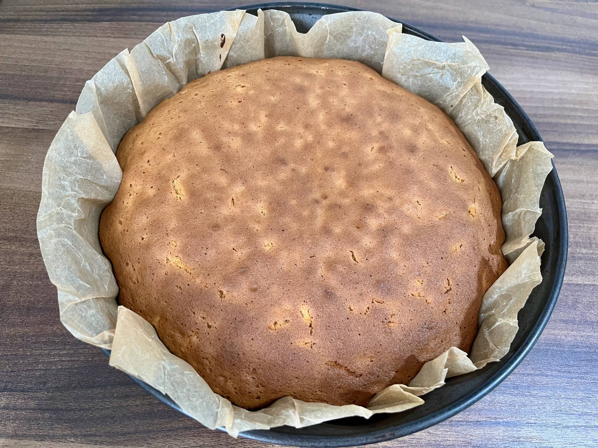 The carrot cake is in a pan, taken straight from the oven