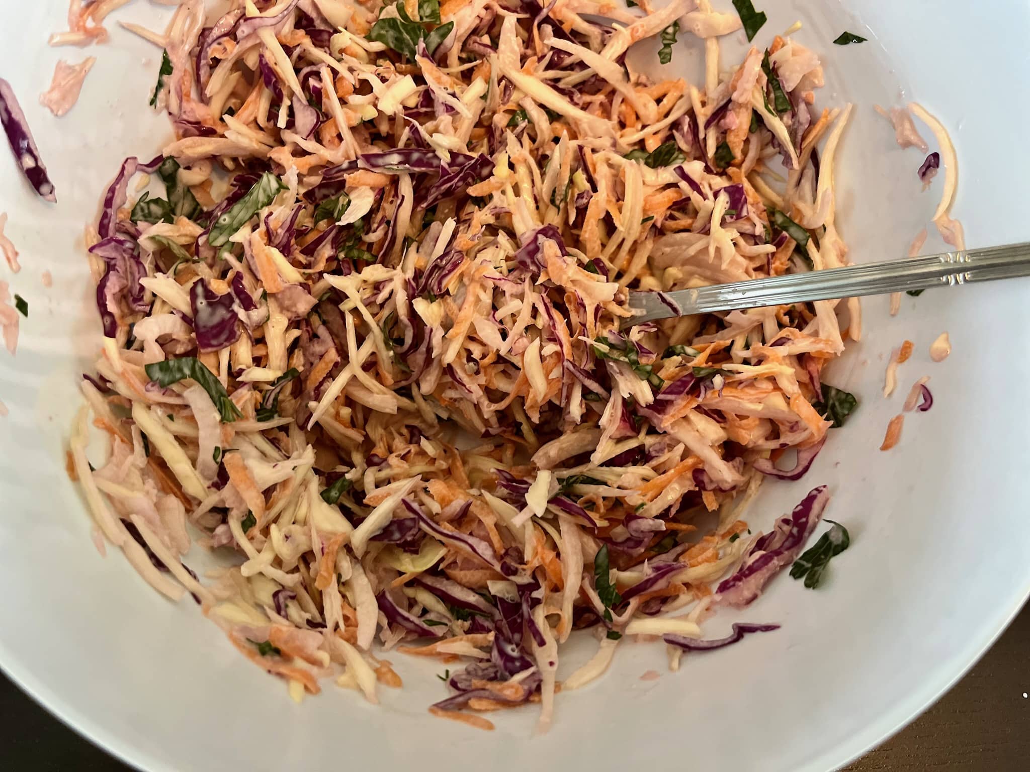 Raw coleslaw mixed with coleslaw dressing creates a perfect salad