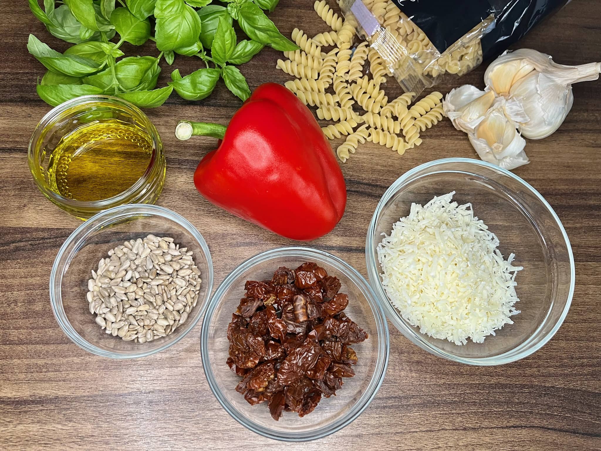 All of the ingredients for red pesto are laid out on the table, ready to be made