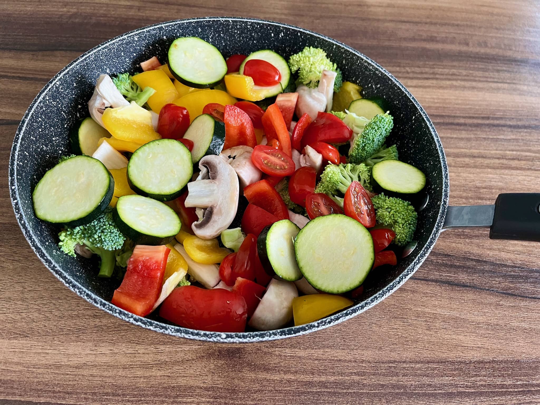 All vegetables in a large pan ready to make Stir Fry