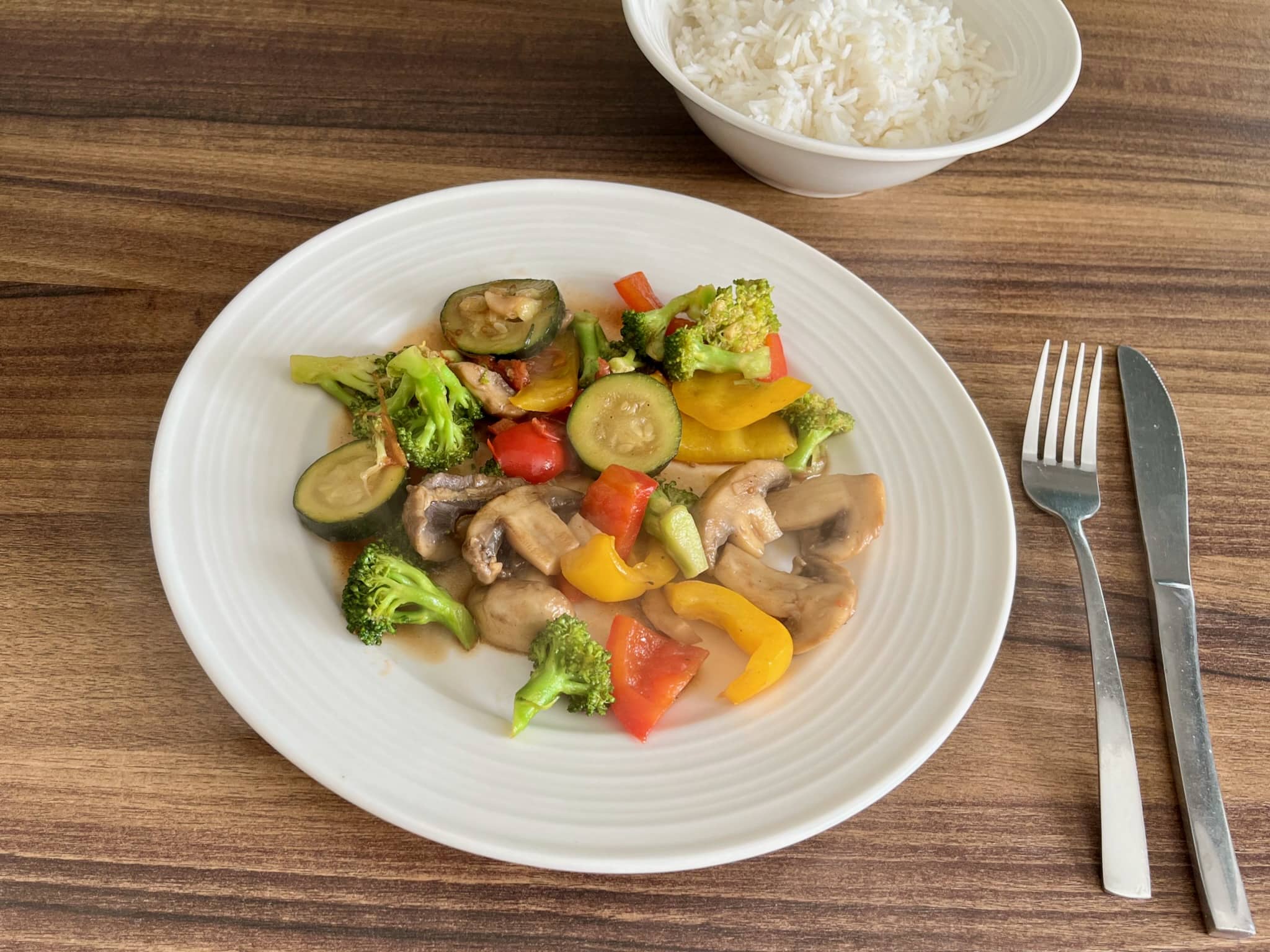 Perfect Stir Fry Vegetables on a plate with a bowl of rice on a side