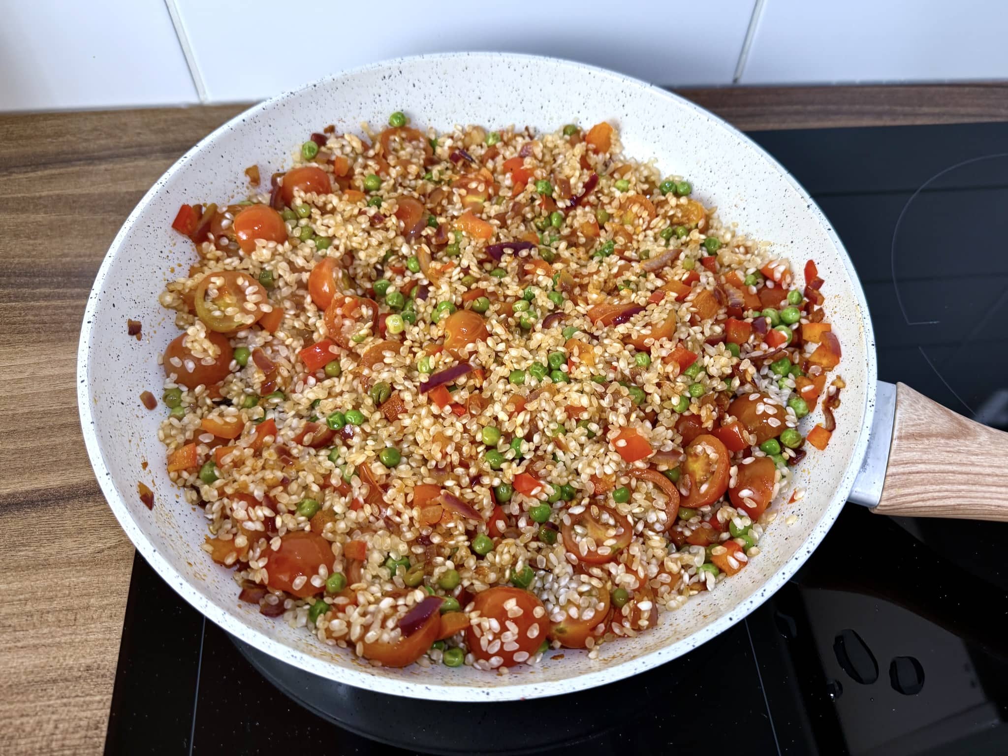 Paella rice added to the fried vegetables
