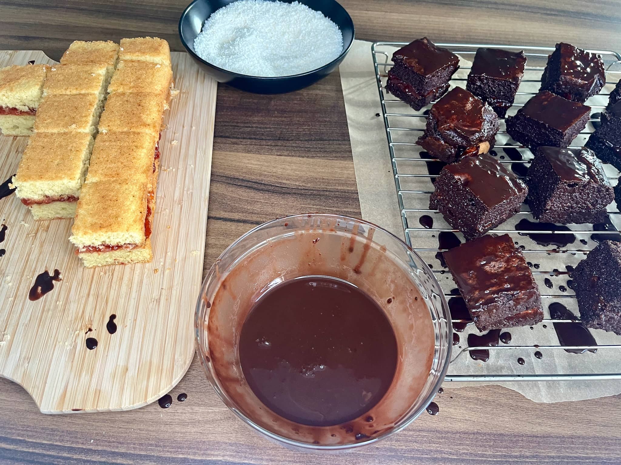 Process of coating sponge squares in a chocolate sauce for making Lamingtons