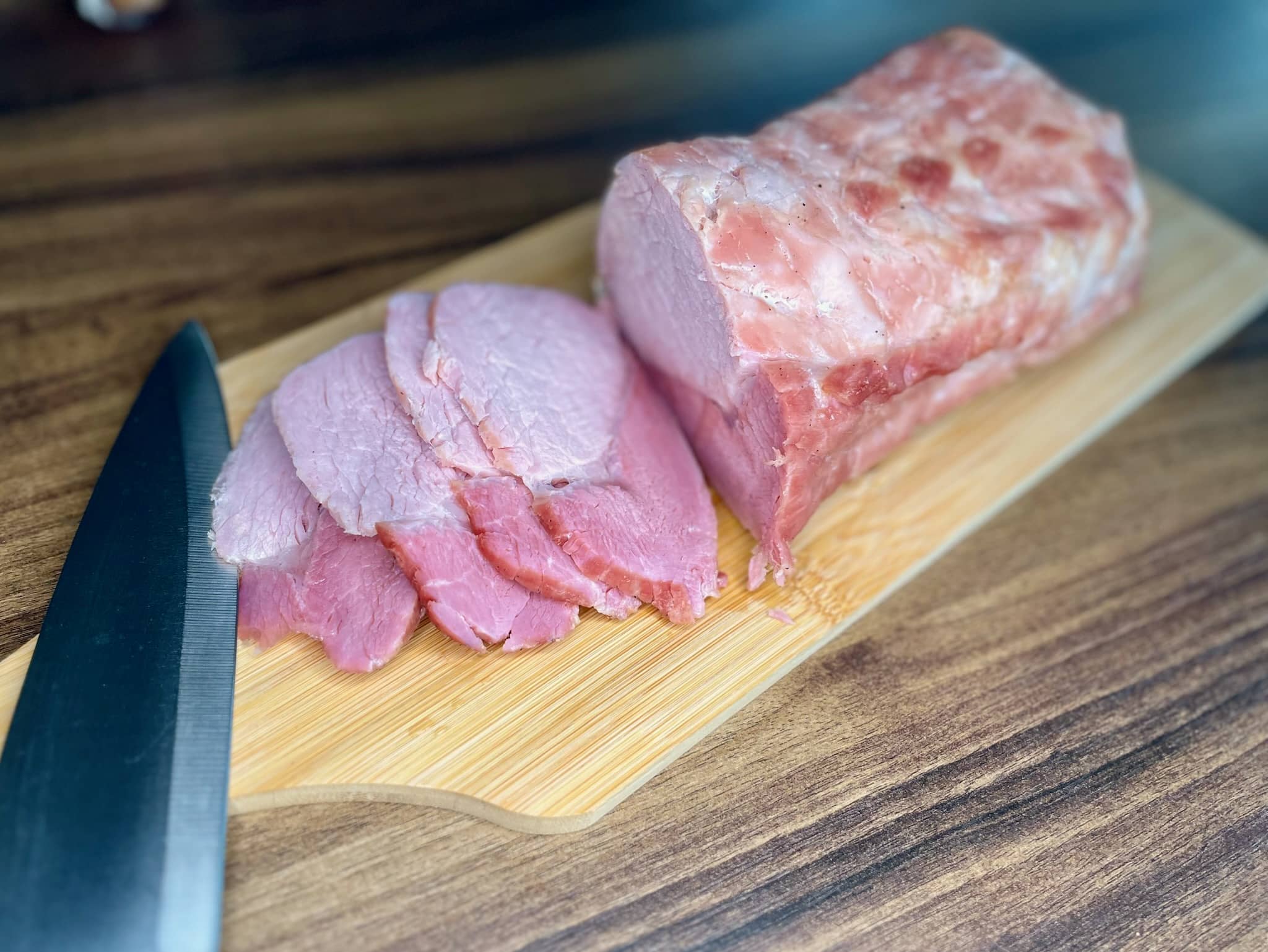 Baked marinated pork loin cliced on a chopping board