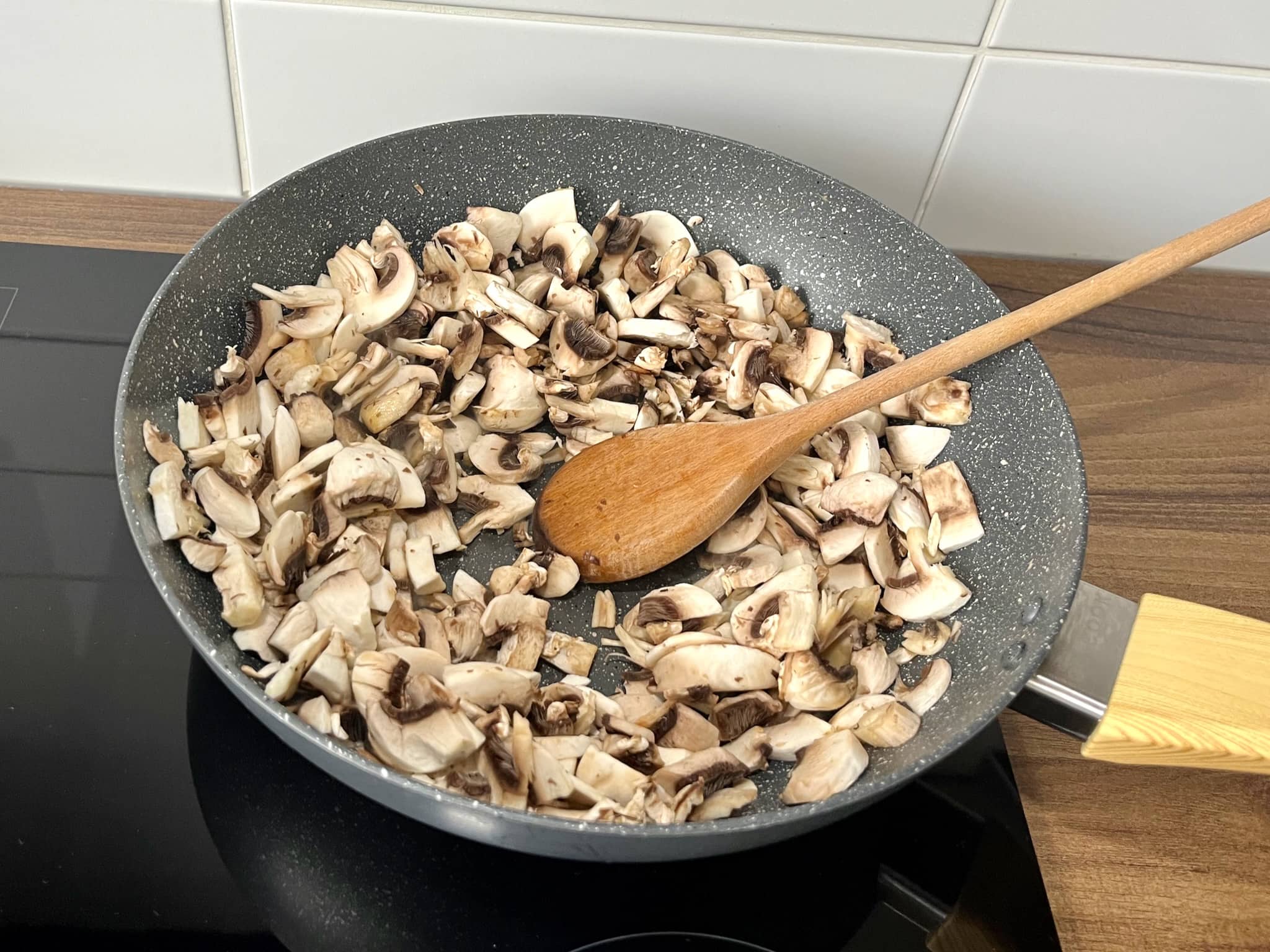 Mushrooms frying in a pan