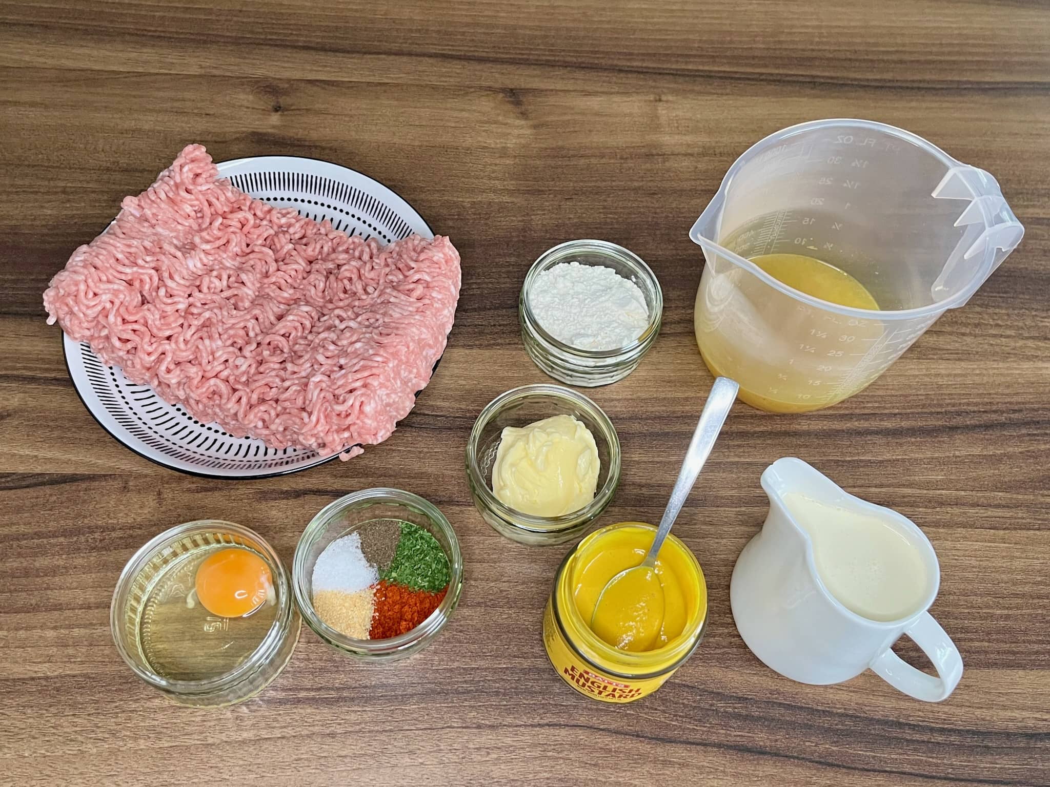 All the ingredients are on the table top, ready to be used to make meatballs in creamy sauce