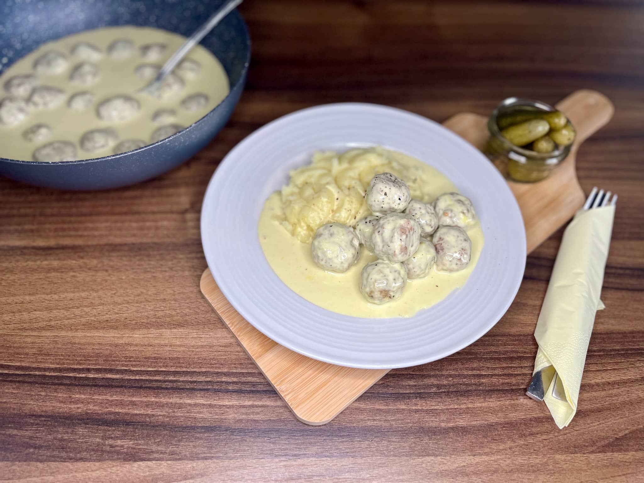 A portion of meatballs in creamy sauce served with mashed potatoes