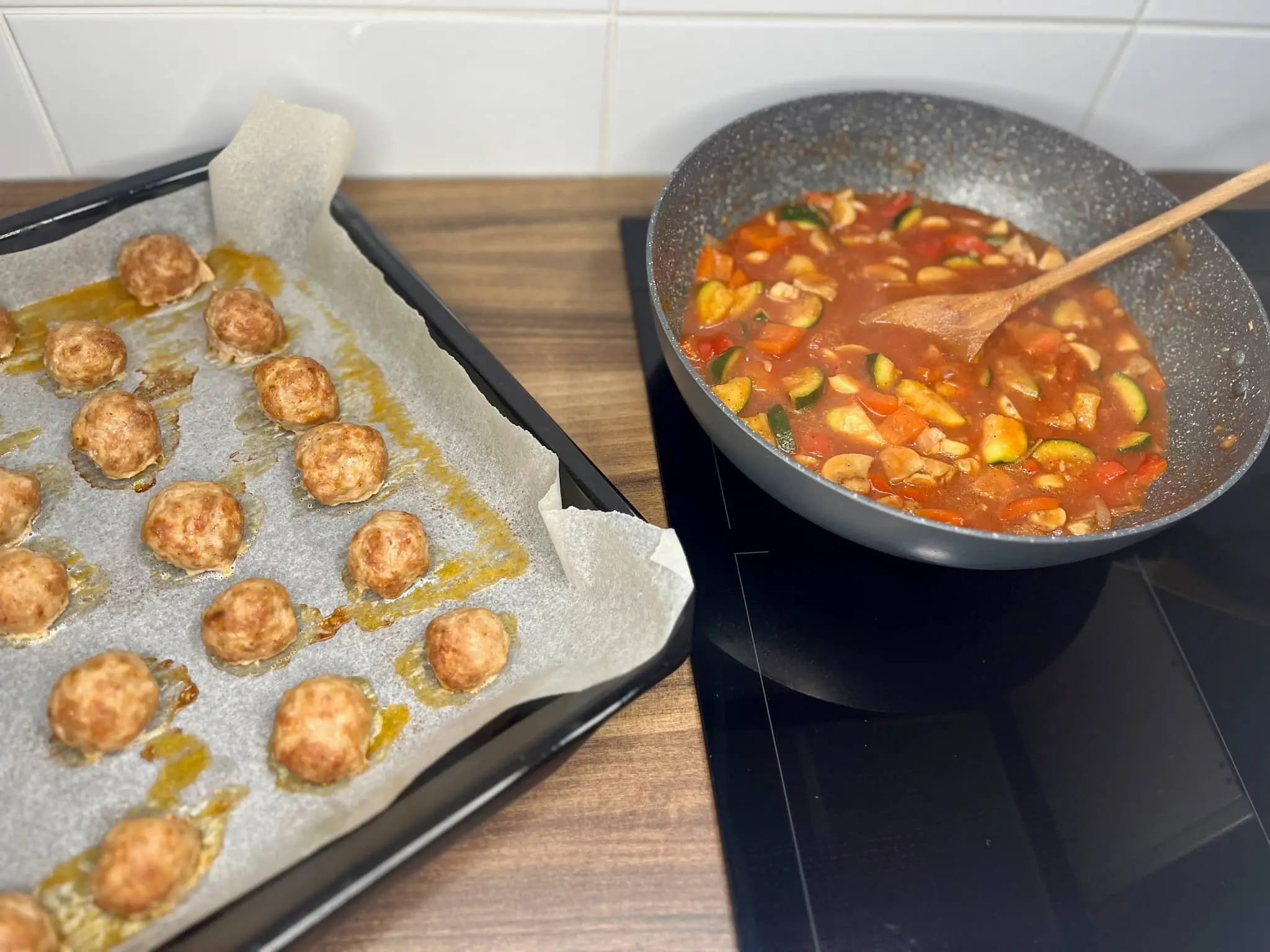 Baked meatballs and cooked sauce, ready to be mixed together.