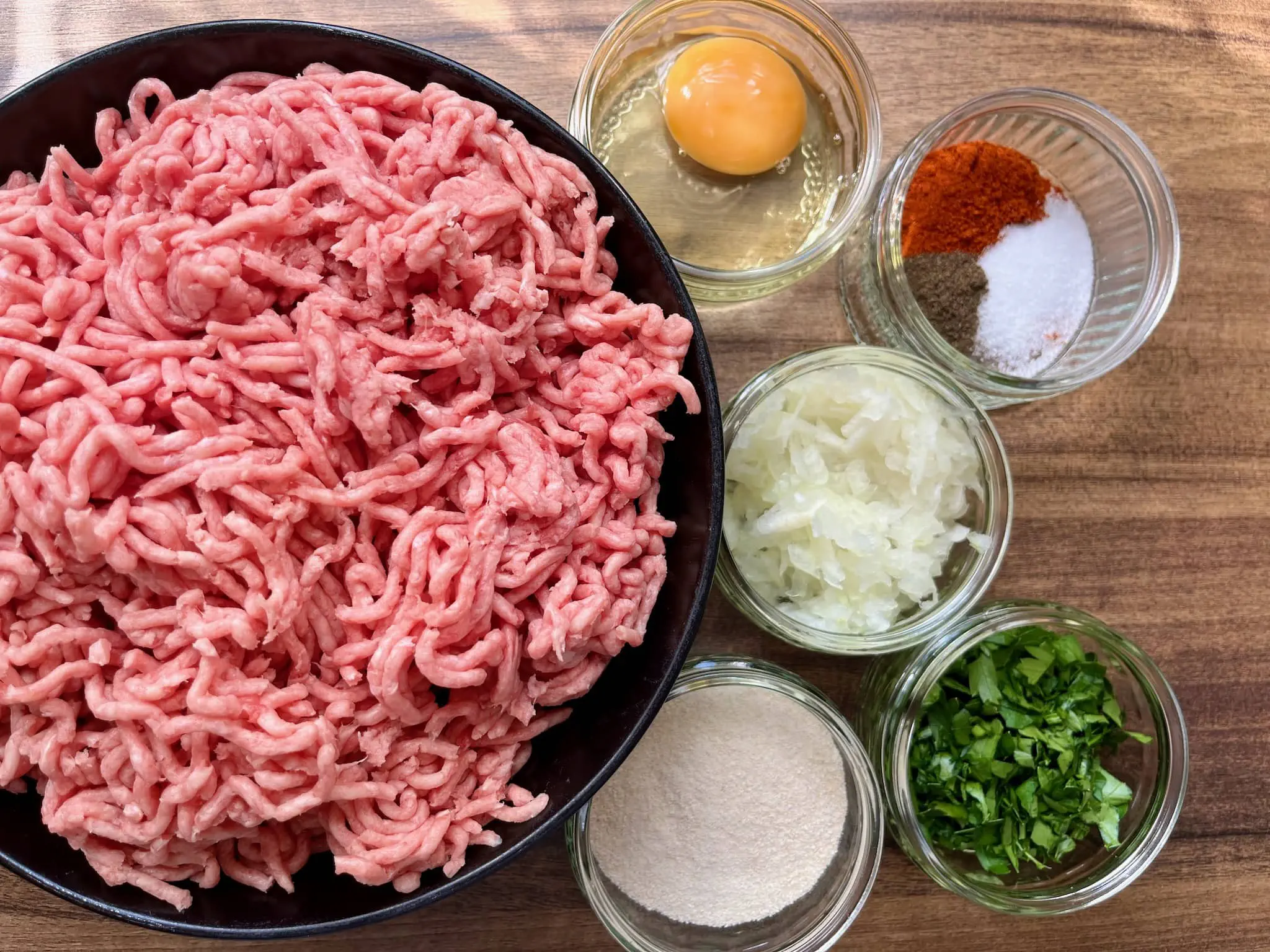 All the ingredients on the tabletop ready to make meatballs
