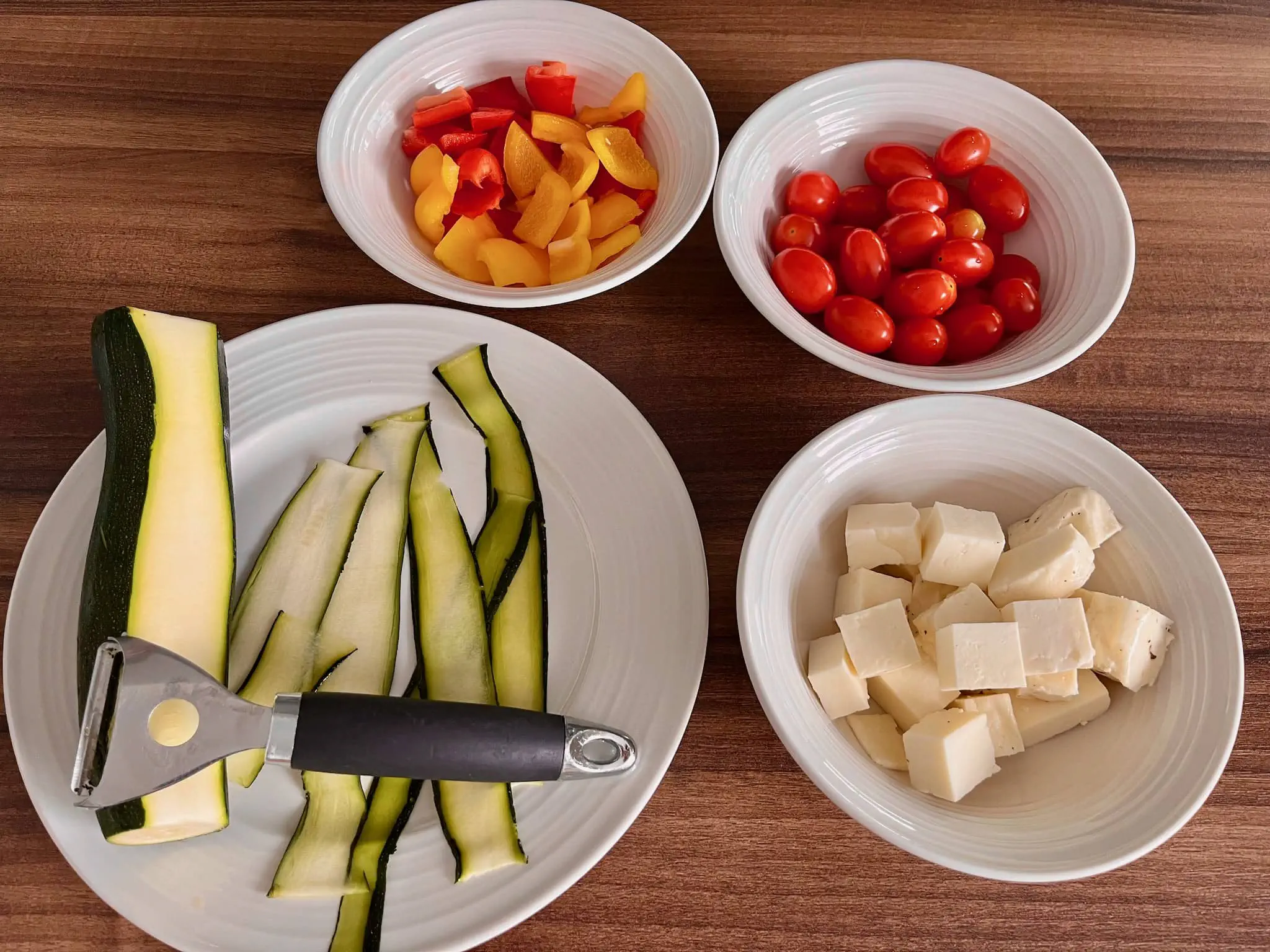 All the vegetables and halloumi cheese on the tabletop ready to make Meatless Skewers