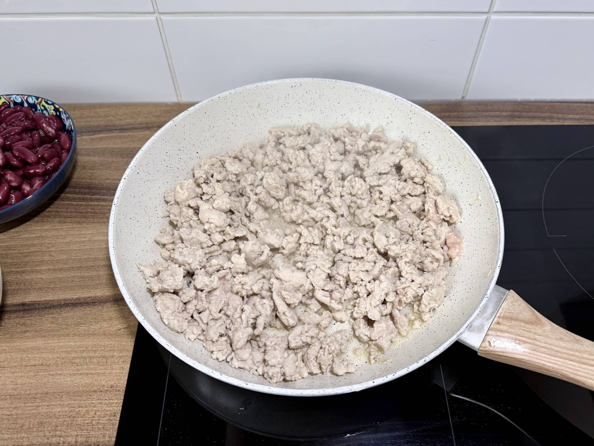 Cooked chicken mince in a skillet