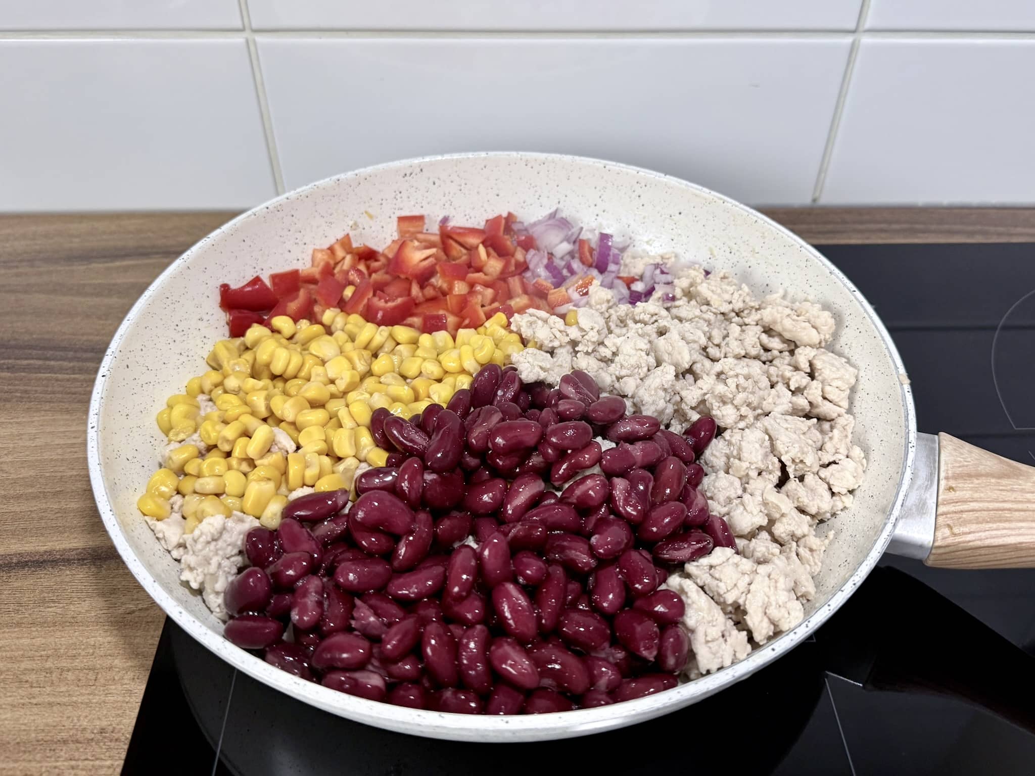Cooked chicken mince with other ingredients in a skillet