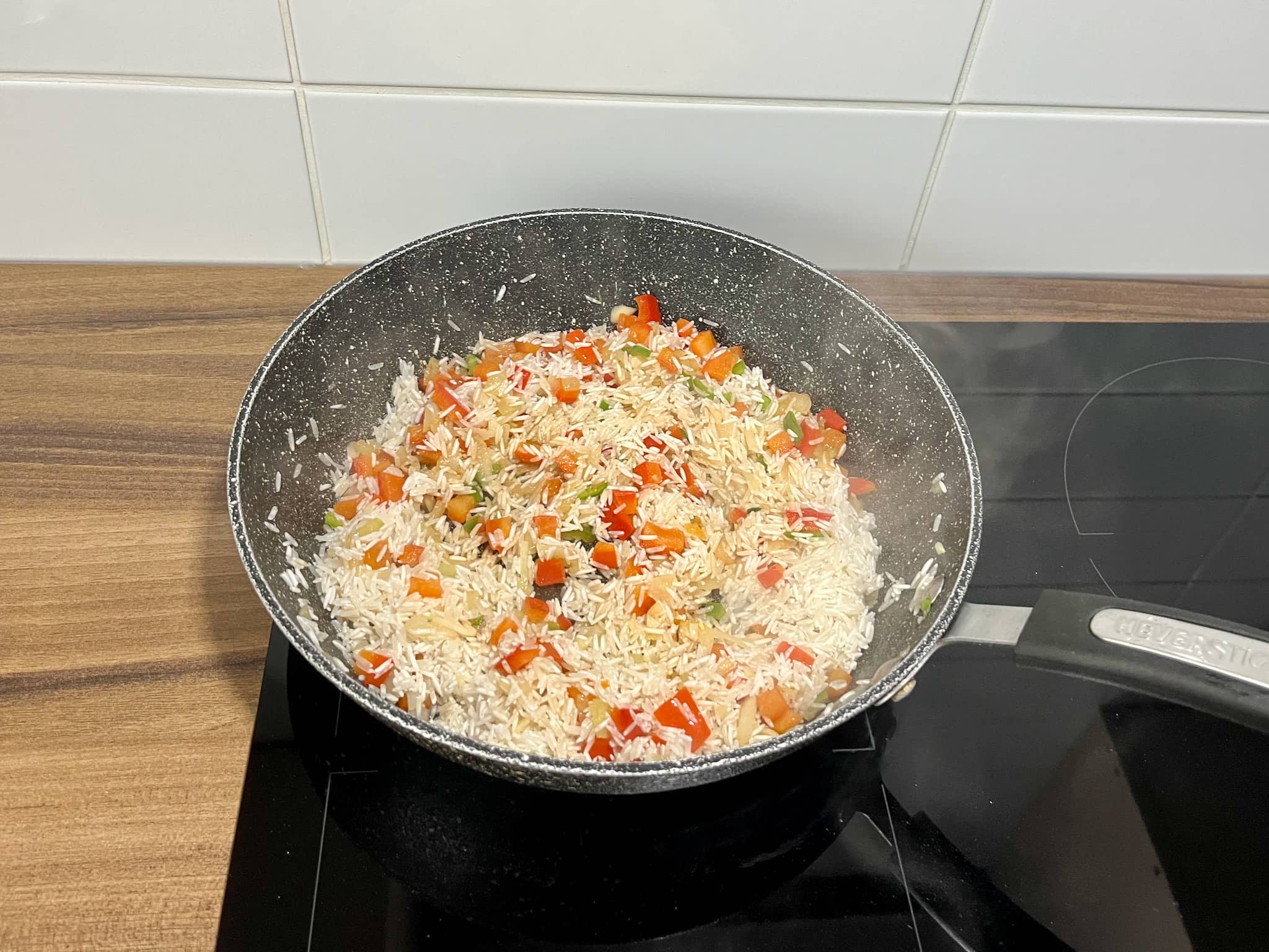 Peppers, onion, garlic and rice in a pan