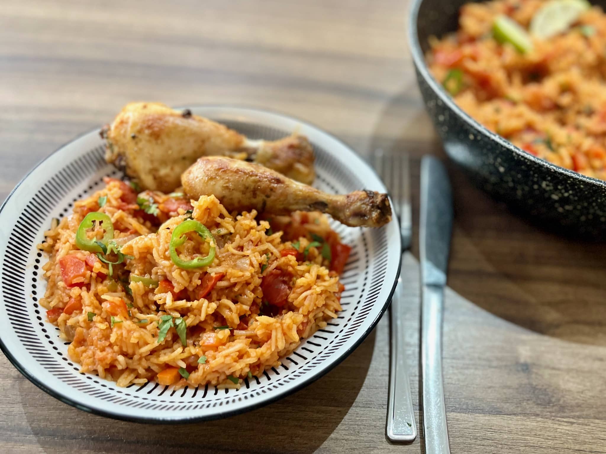 Mexican Rice on a plate served with Mexican-Style Chicken drumsticks