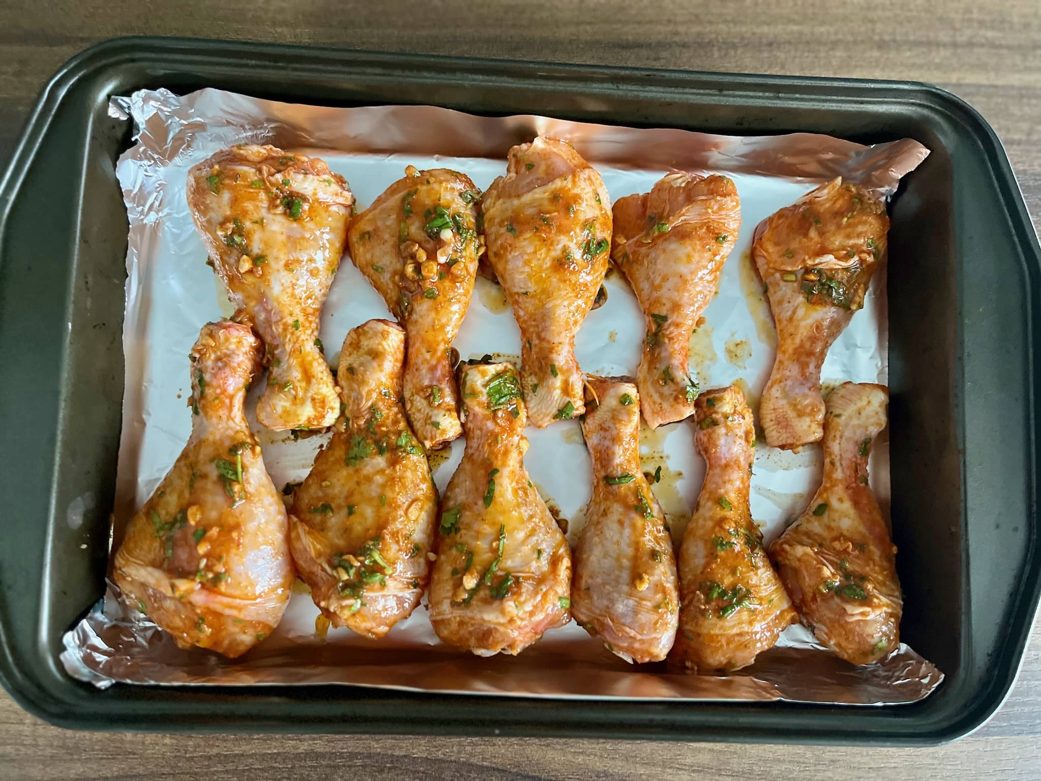 Chicken drumstick in a tray coated with Mexican-style marinade
