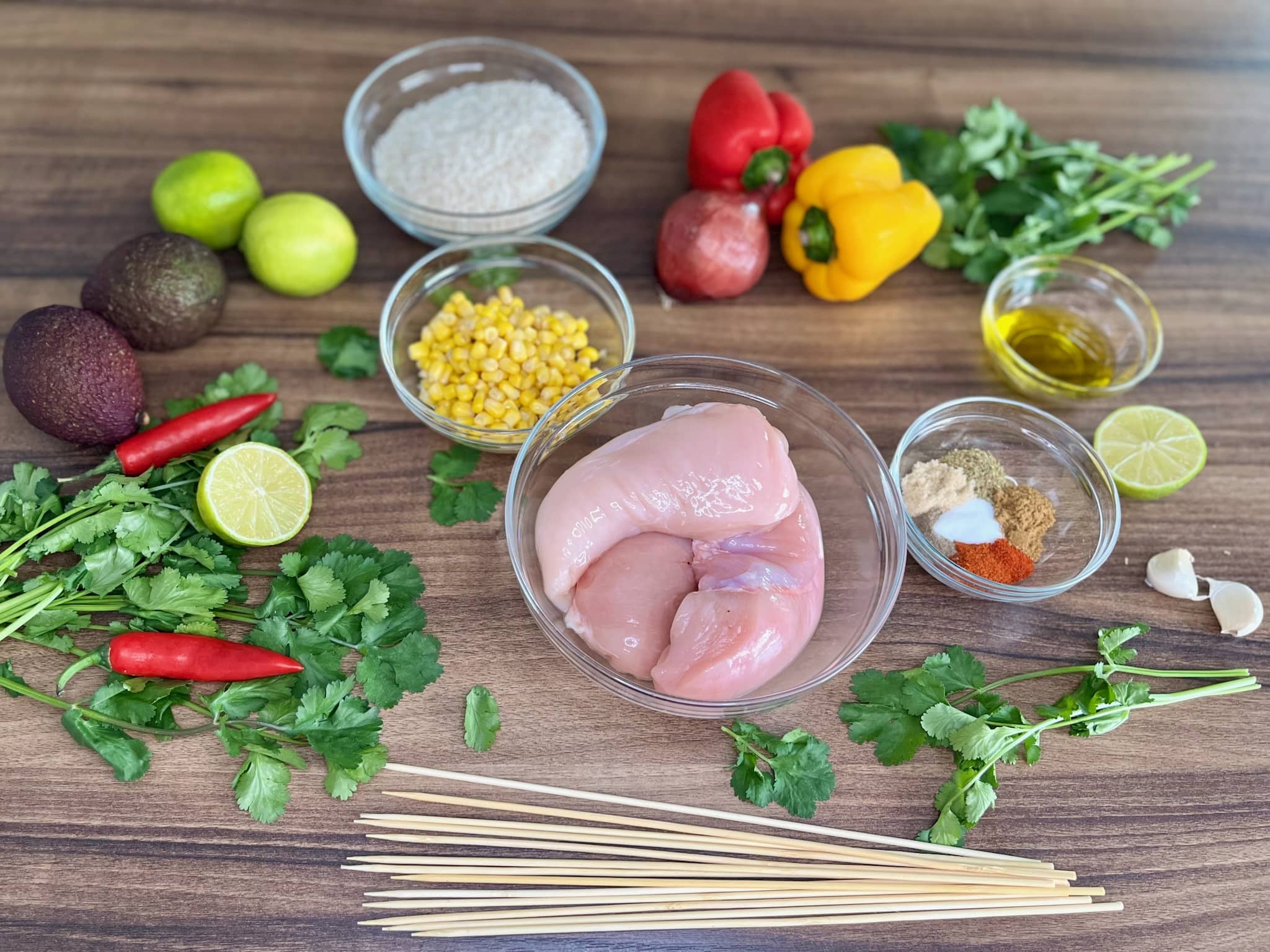 All the ingredients are laid out on the table, ready for making Mexican-Style Skewers