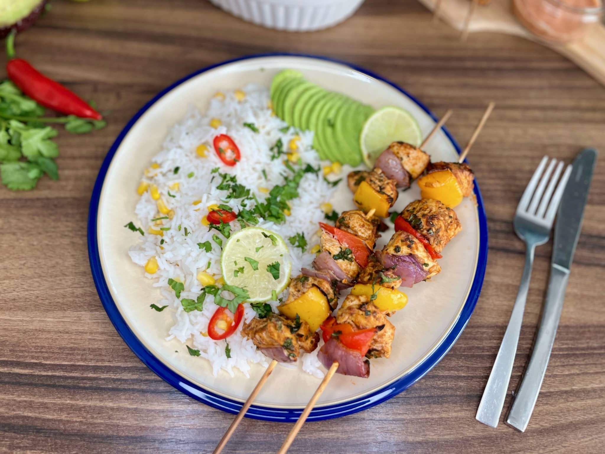 Mexican-Style Skewers served with Rice on a plate