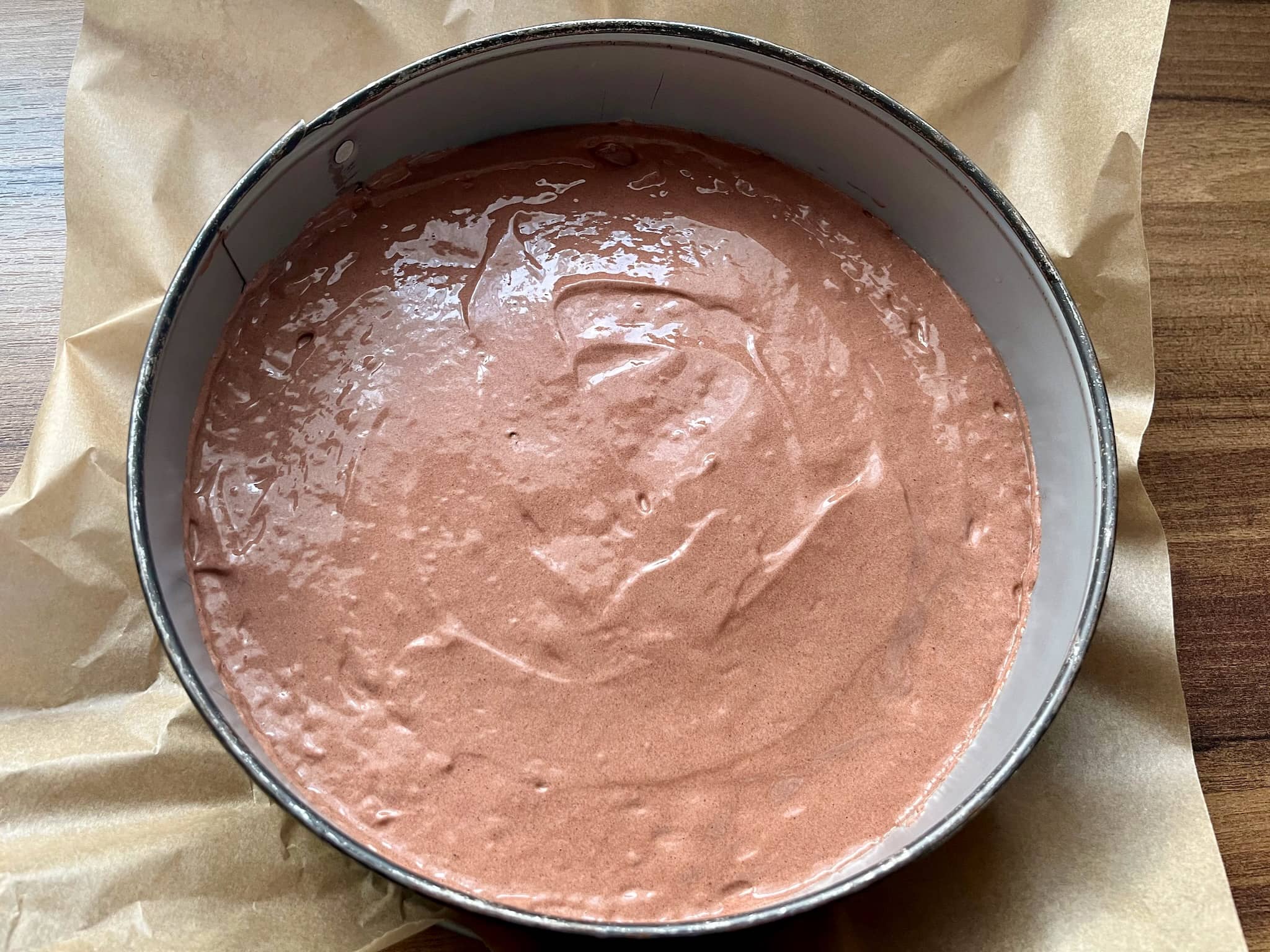 Cake mix in a round tin ready for baking