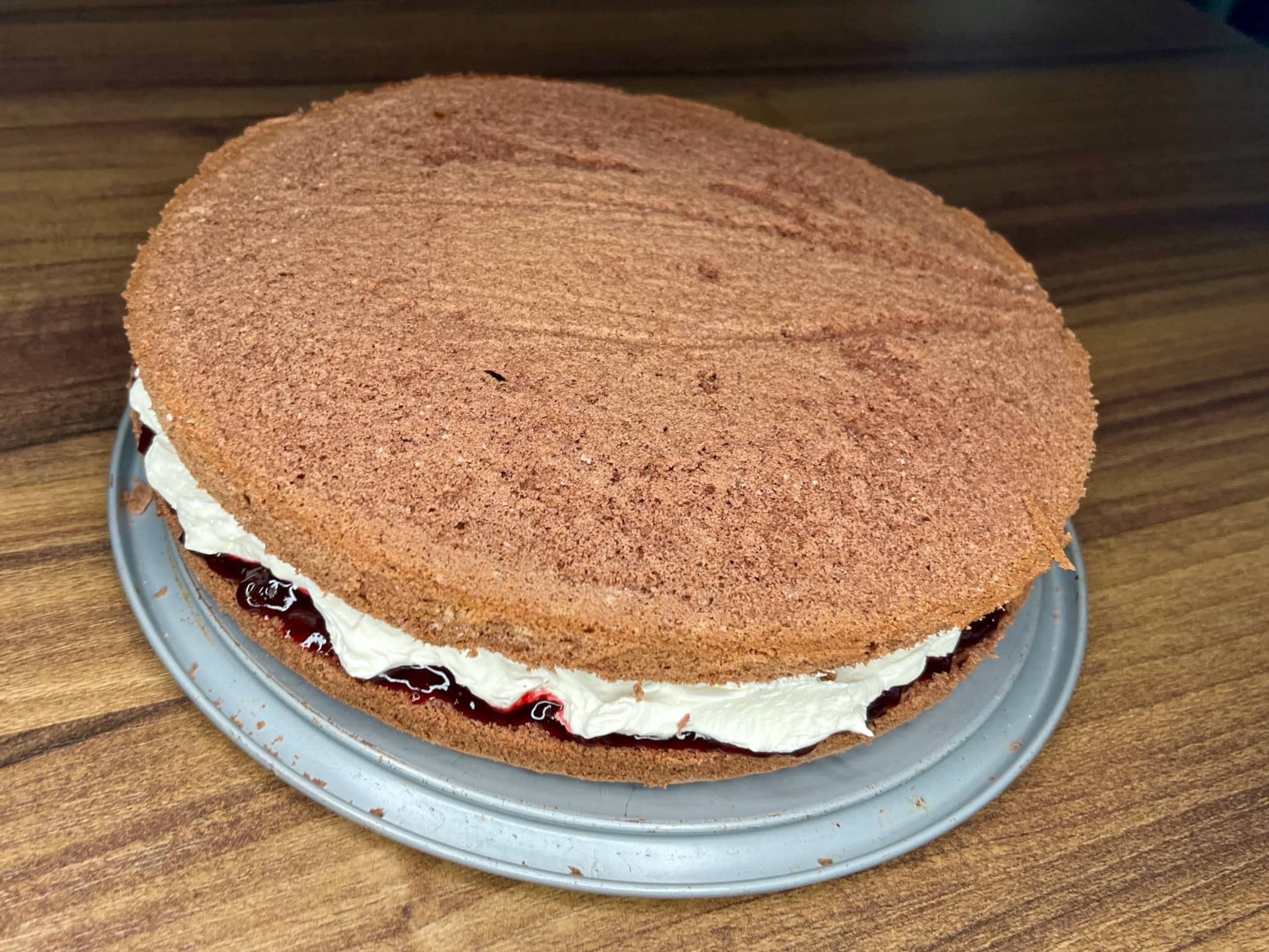 Another part of the cake is placed on top making cake sandwich
