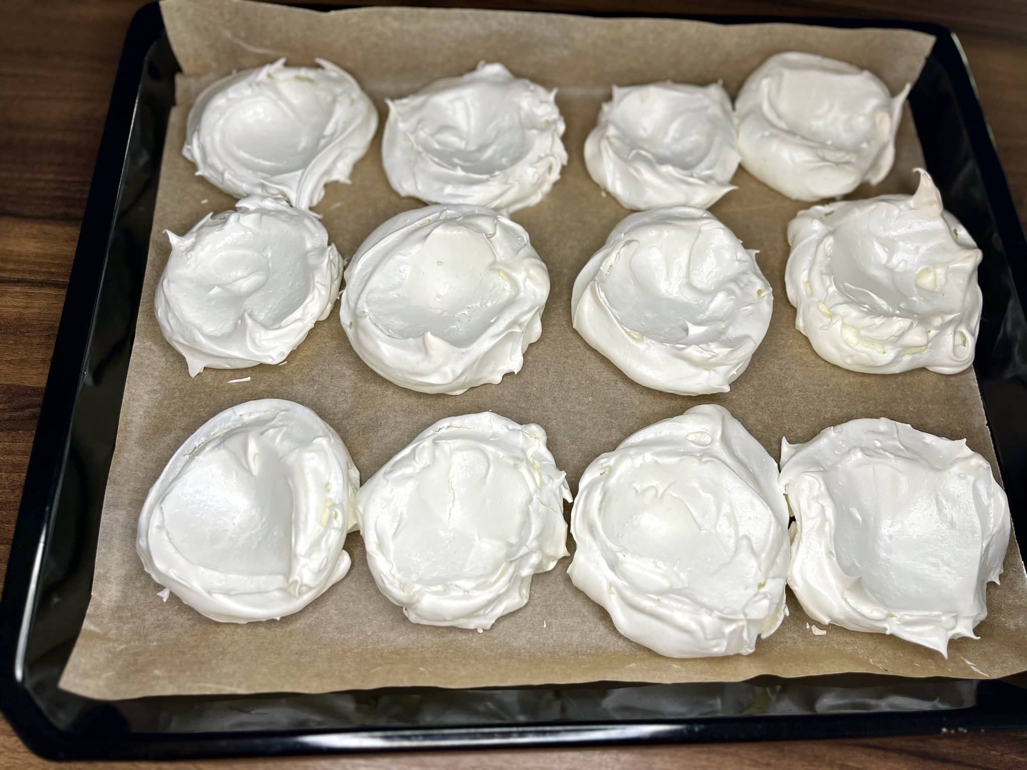Nicely baked meringues on a baking tray
