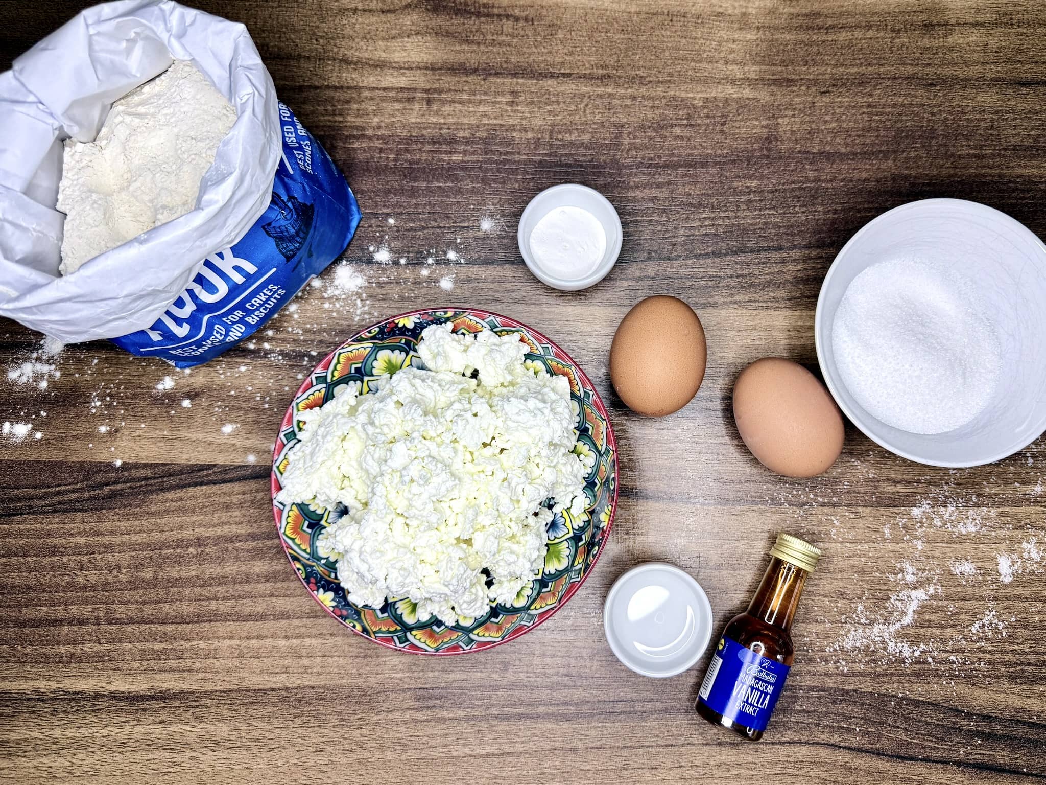 All ingredients on a tabletop ready to make mini doughnuts