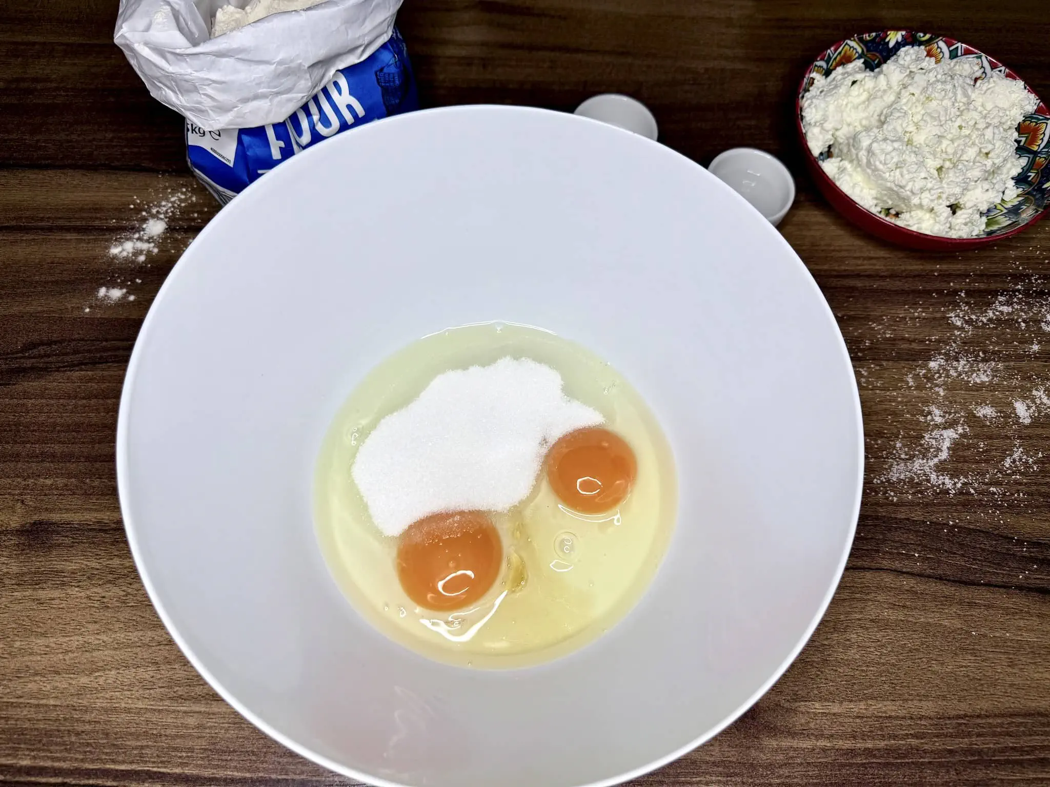 Eggs and sugar in a mixing bowl