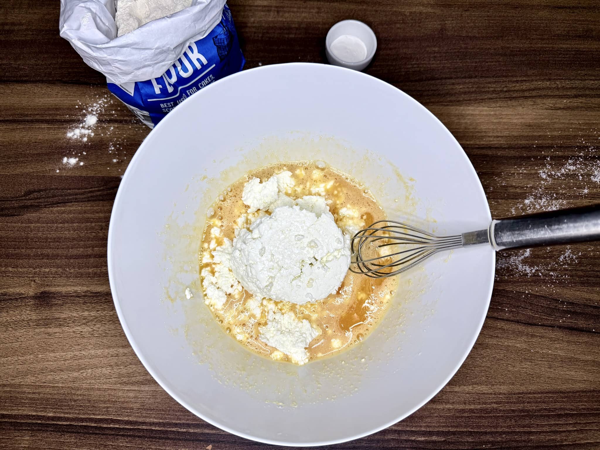 Quark cheese added to a mixing bowl with the other ingredients