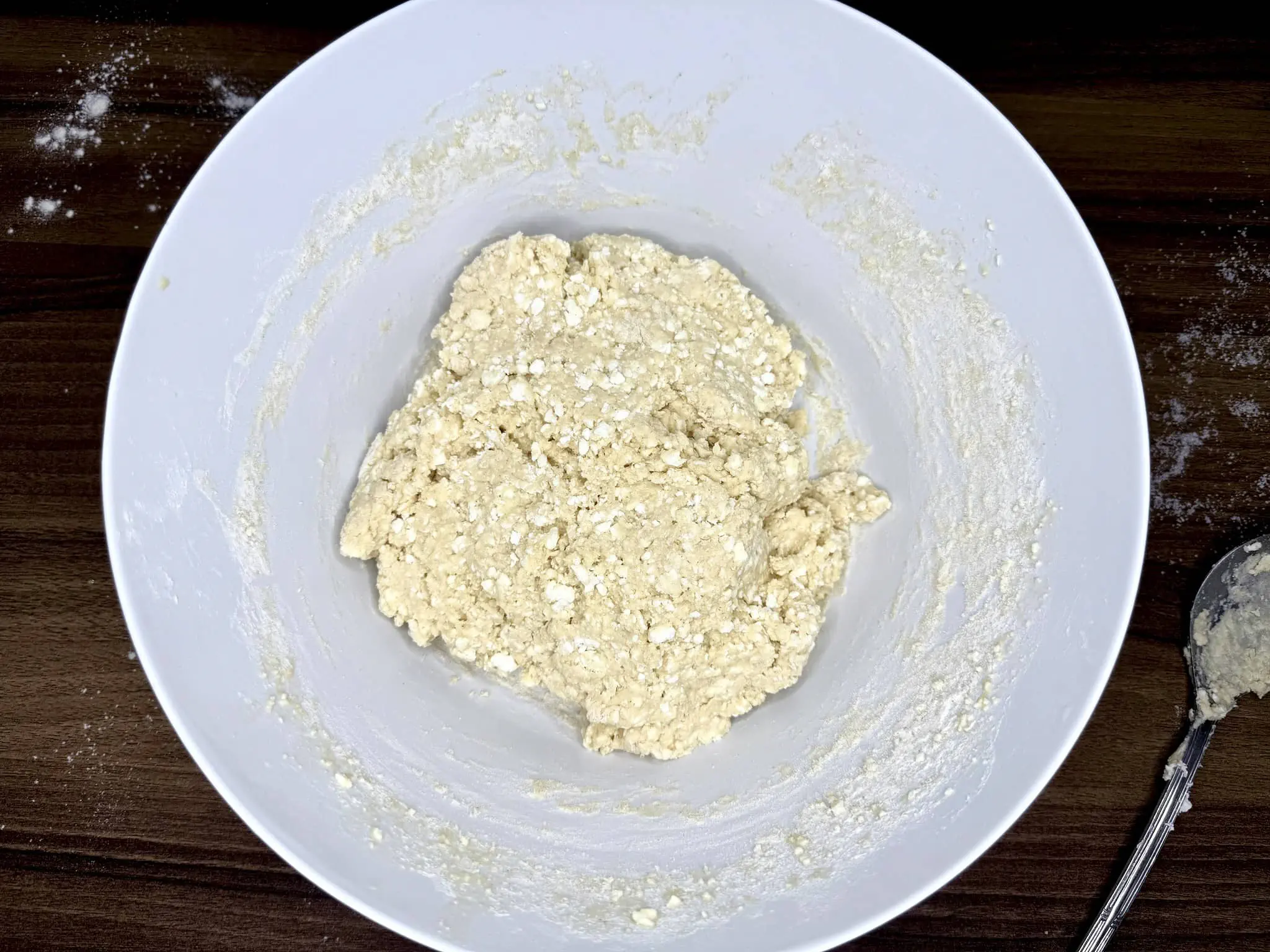 Nicely folded dough for doughnuts in a mixing bowl