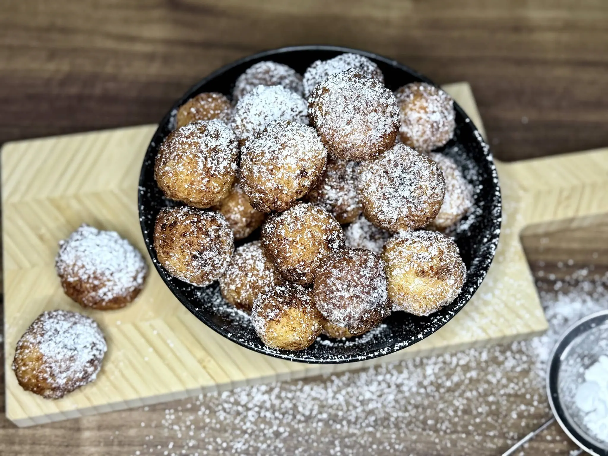 Mini doughnuts with quark cheese in a bowl, nicely dusted with icing sugar