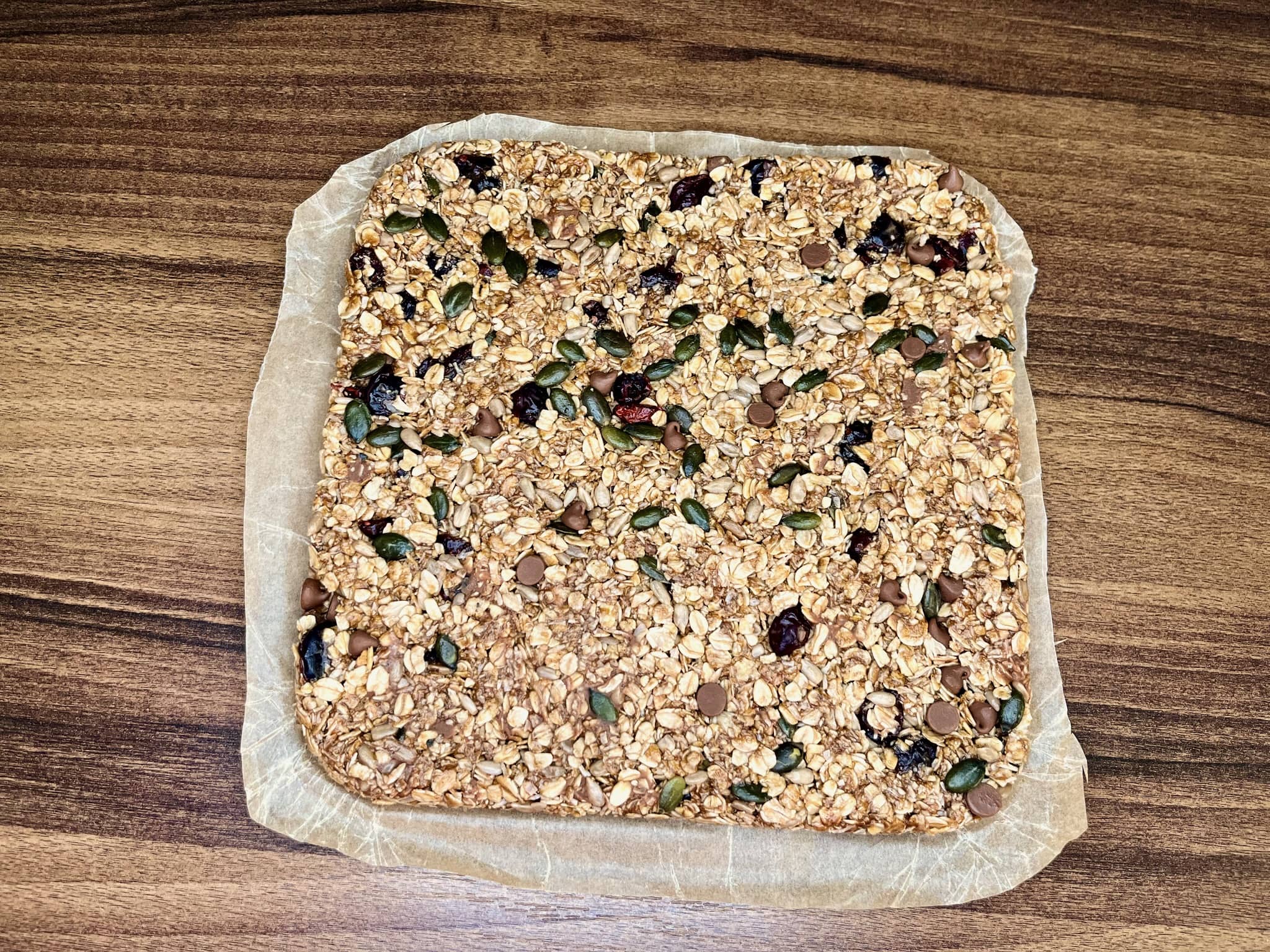 The muesli bar mixture is set aside after being removed from the tray