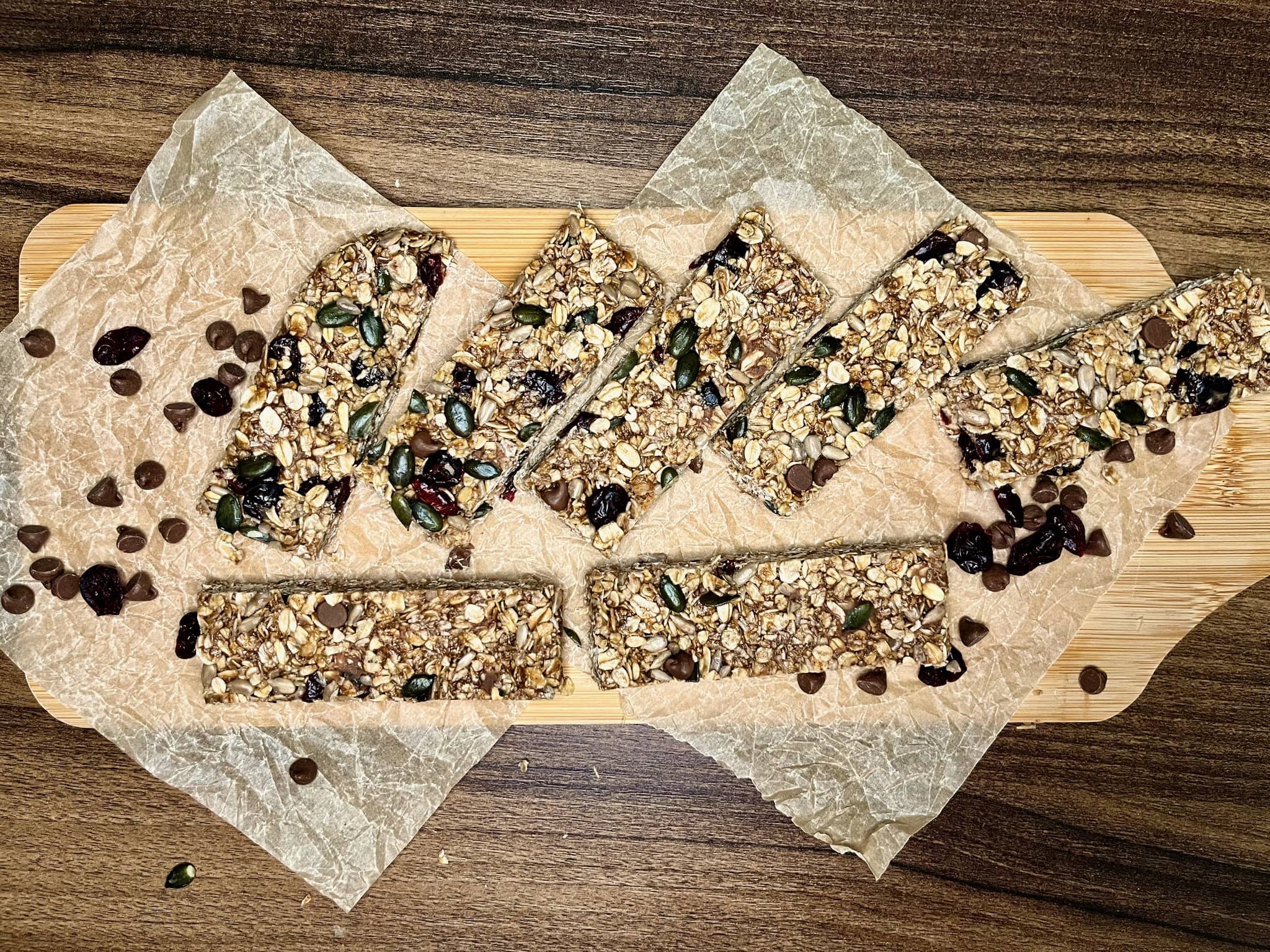 The muesli mixture has been chopped into bars on a chopping board