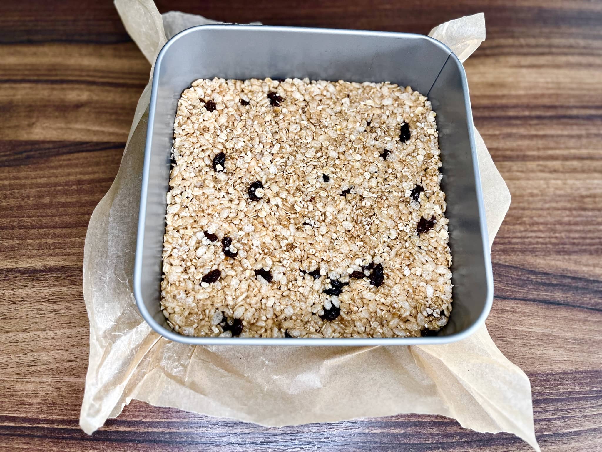 Nicely flatten the Rice Krispie mixture in a square tin