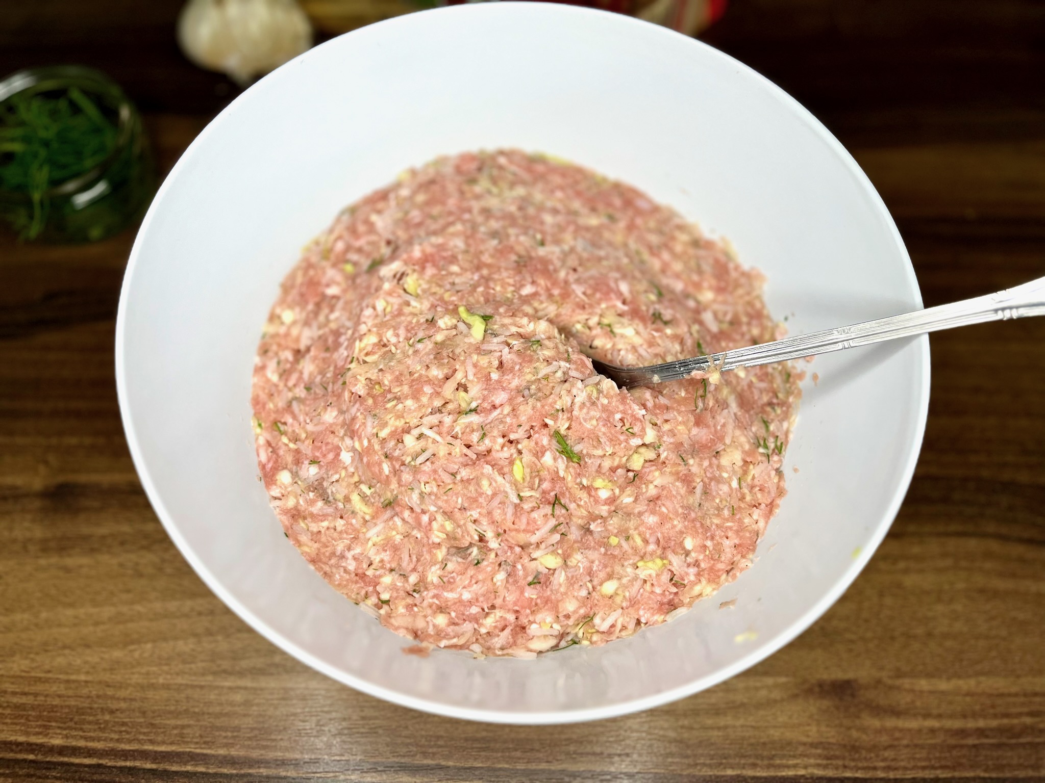 Gently mixed grated cabbage with minced meat in a large bowl