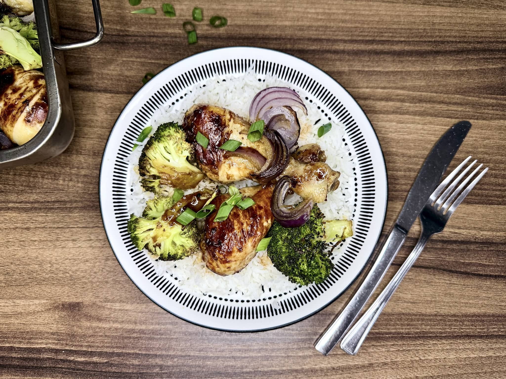 A portion of Oriental Spiced Chicken Drumsticks served on top of rice