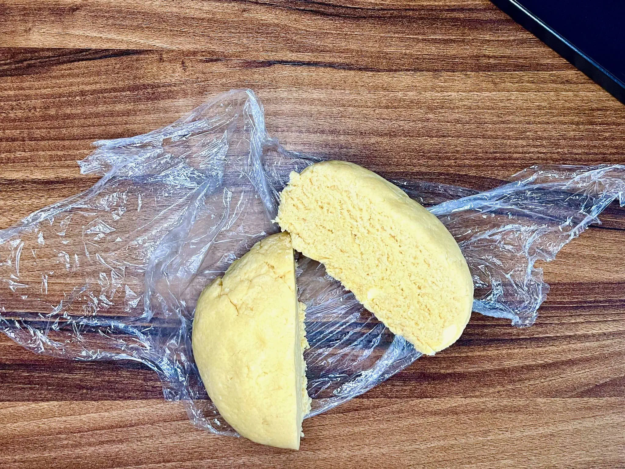 The rested dough ball is divided into two equal portions