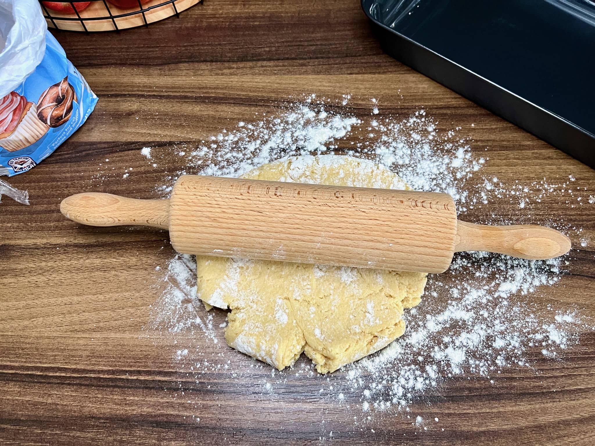 Using a rolling pin, roll out one portion of the dough on a lightly floured surface