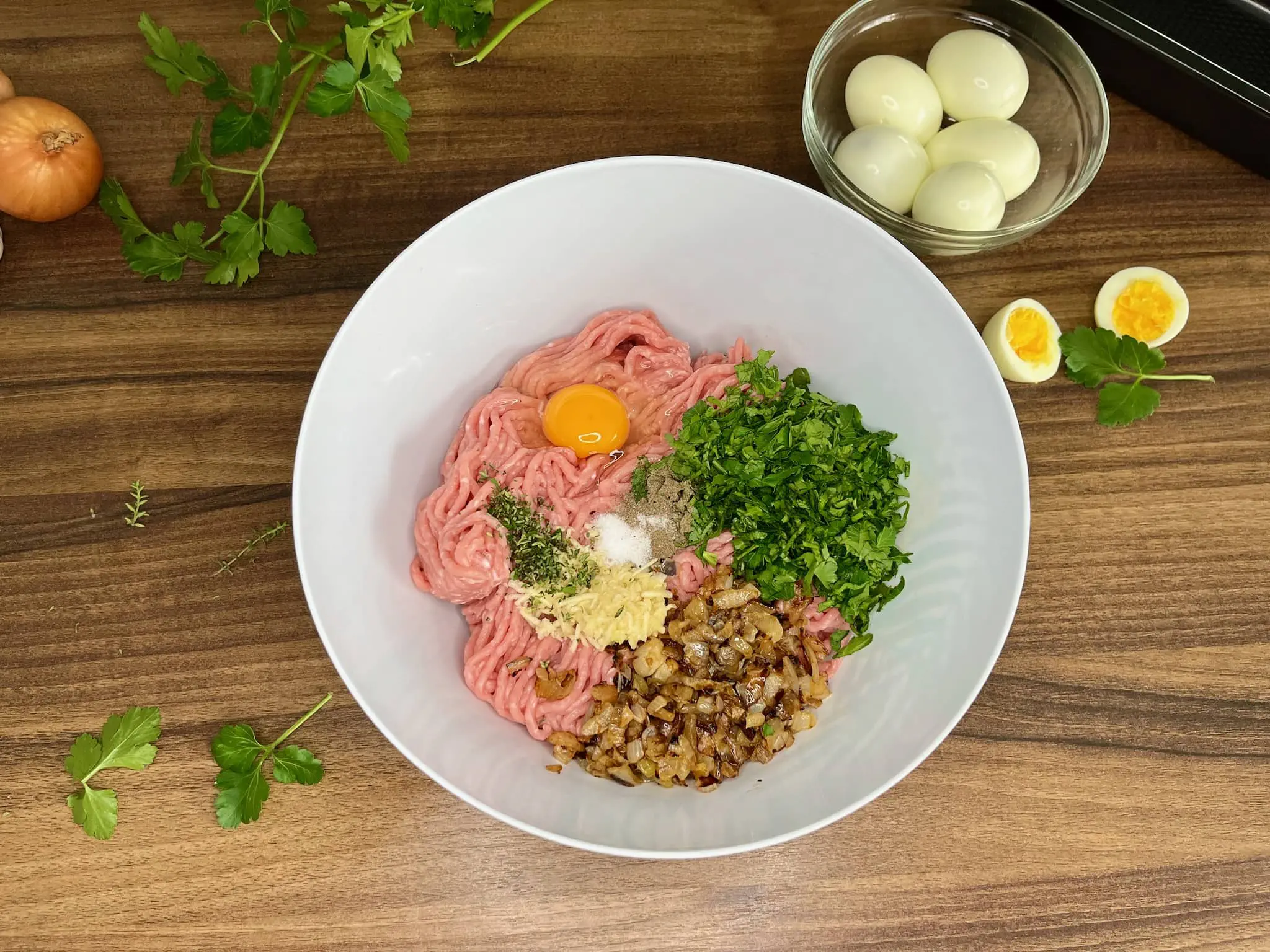 Mixing Pork mince with other ingredients in a bowl