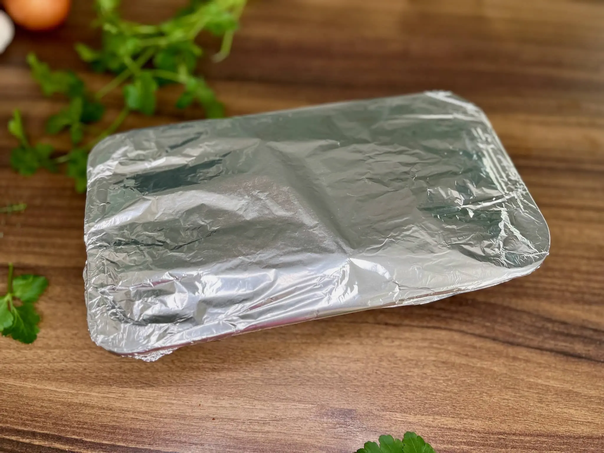 Tin covered with foil ready to put into oven