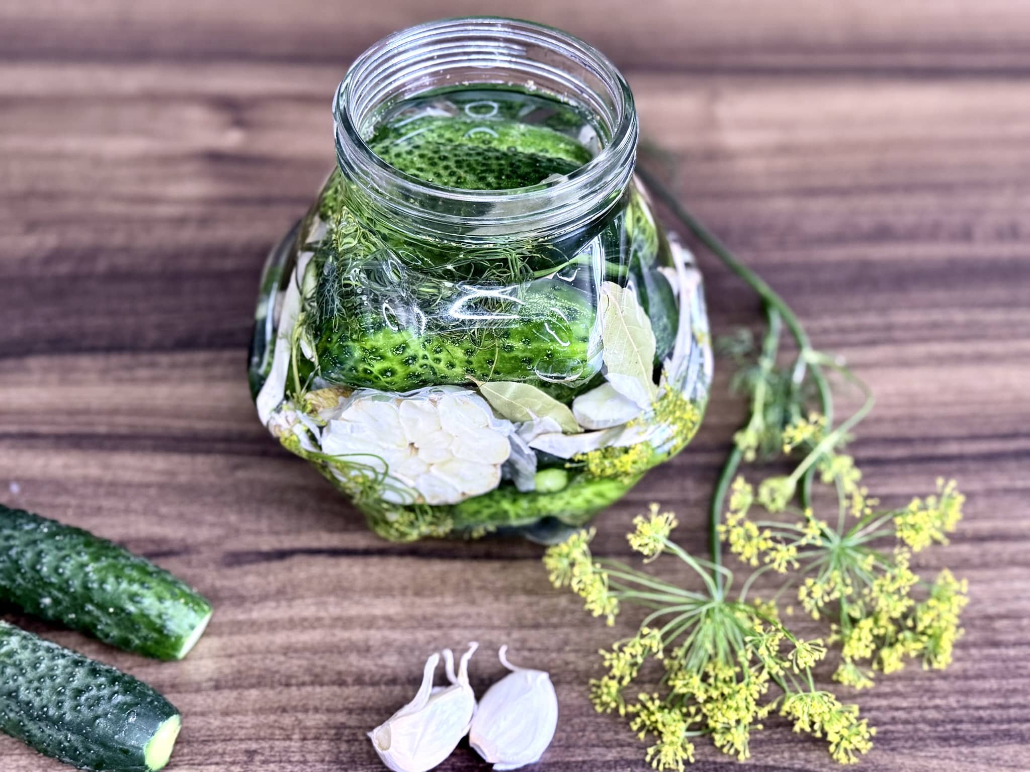 Cucumbers packed in a jar with pickling spices