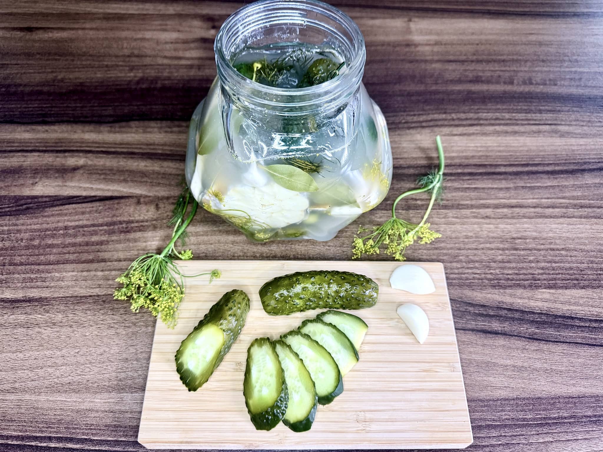 A jar after 48 hours with a sliced cucumber on a chopping board